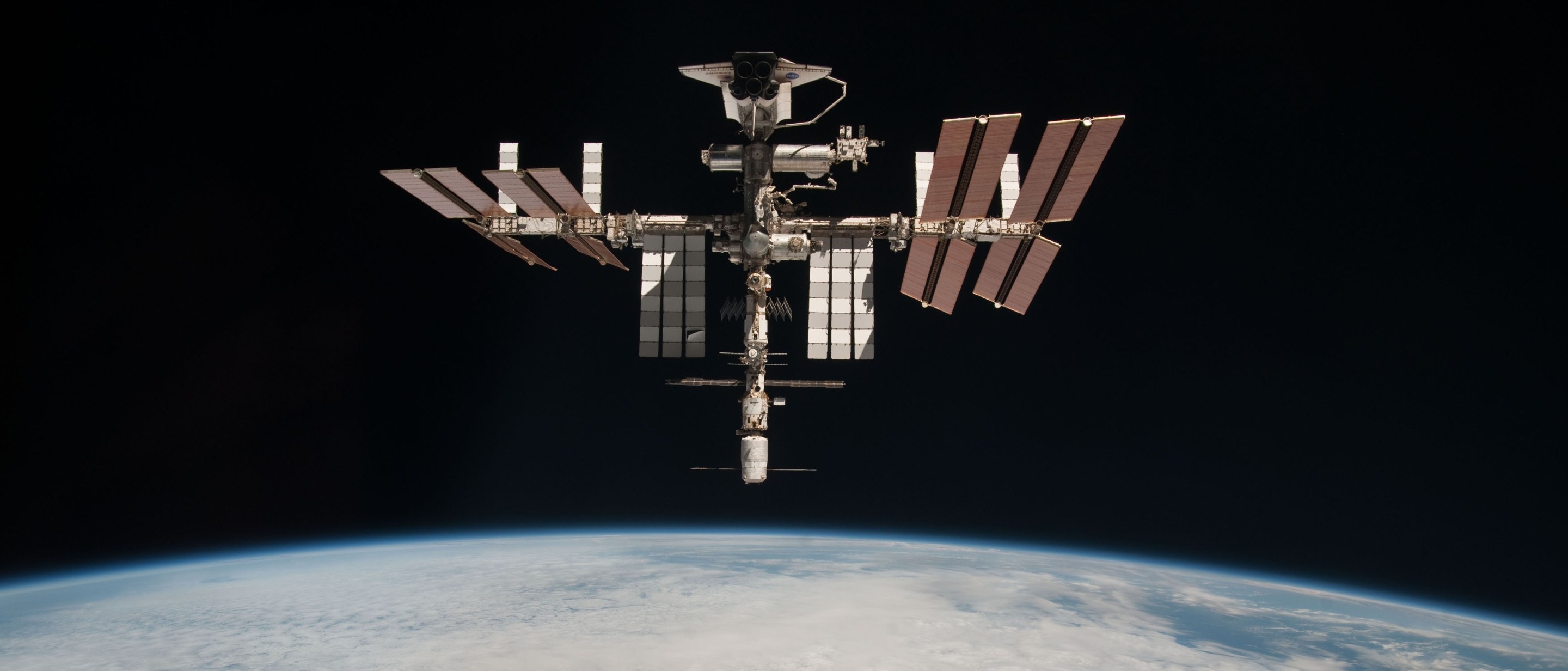 IN SPACE - MAY 23: In this handout image provided by the European Space Agency (ESA) and NASA, the International Space Station and the docked space shuttle Endeavour orbit Earth during Endeavour's final sortie on May 23, 2011 in Space. Italian astronaut Paolo Nespoli captured the first-ever images of an orbiter docked to the International Space Station from the viewpoint of a departing vessel as he returned to Earth in a Soyuz capsule. (Photo by Paolo Nespoli - ESA/NASA via Getty Images)