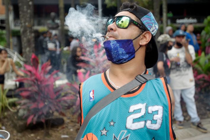 MEDELLIN, COLOMBIA - DECEMBER 12: A man smokes marijuana during a march to legalize marijuana on December 12, 2020 in Medellin, Colombia.