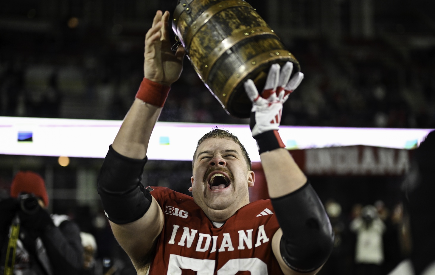 Indiana Hoosiers OL Mike Katic (56) celebrates with the Old Oaken Bucket following a college football game between the Purdue Boilermakers and Indiana Hoosiers on November 30, 2024 at Memorial Stadium in Bloomington, IN