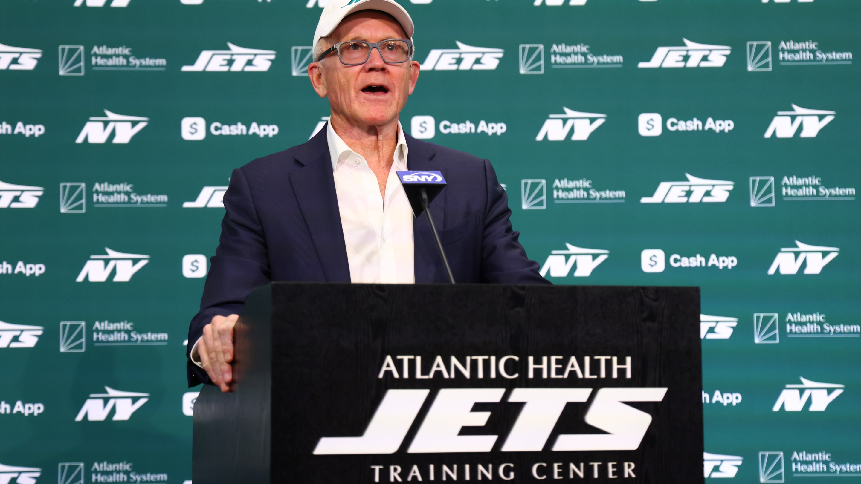 New York Jets owner Woody Johnson speaks at the press conference introducing head coach Aaron Glenn and general manager Darren Mougey on January 27, 2025.
