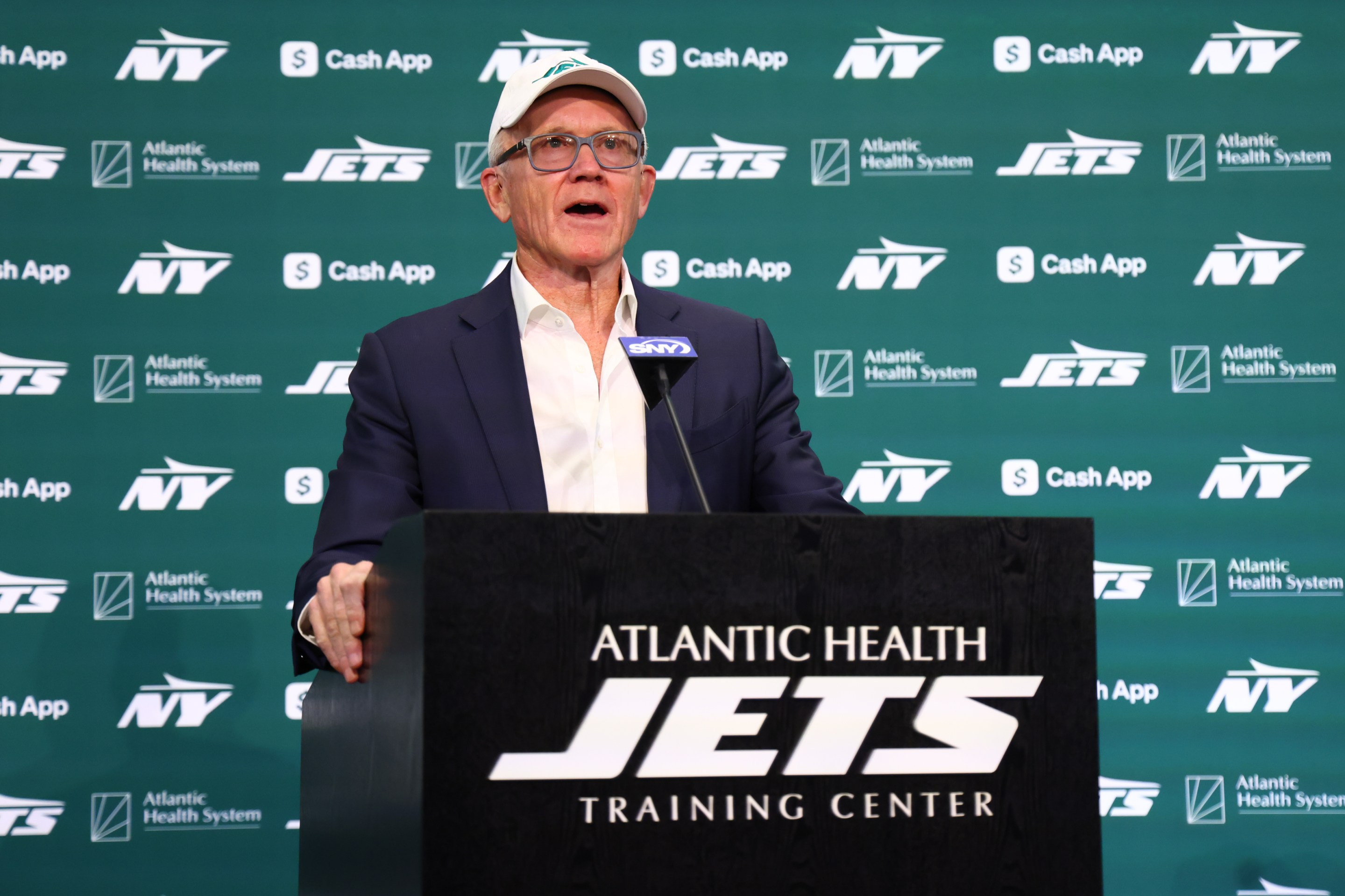New York Jets owner Woody Johnson speaks at the press conference introducing head coach Aaron Glenn and general manager Darren Mougey on January 27, 2025.