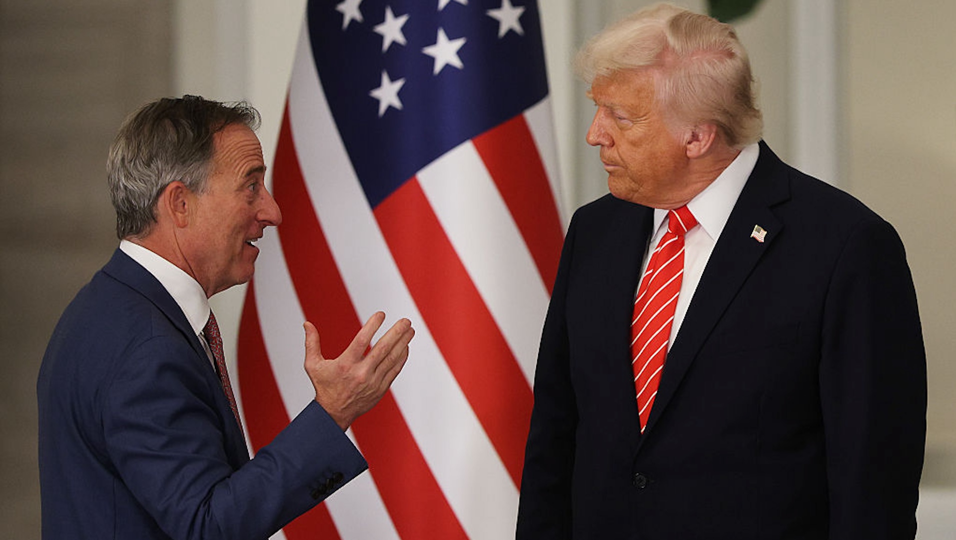 U.S. President Donald J. Trump (R) talks with Washington Commanders owner Josh Harris before a state dinner at the Lusail Palace on May 14, 2025, in Doha, Qatar. The visit underscores the strategic partnership between the United States and Qatar, focusing on regional security and economic collaboration.