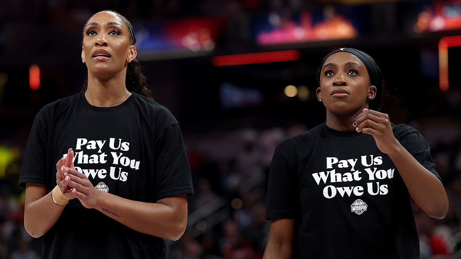 A’ja Wilson #22 of the Las Vegas Aces and Jackie Young #0 of the Las Vegas Aces wear shirts saying "Pay us what you owe us" prior to the 2025 AT&amp;T WNBA All-Star Game at Gainbridge Fieldhouse on July 19, 2025 in Indianapolis, Indiana. NOTE TO USER: User expressly acknowledges and agrees that, by downloading and or using this photograph, User is consenting to the terms and conditions of the Getty Images License Agreement.