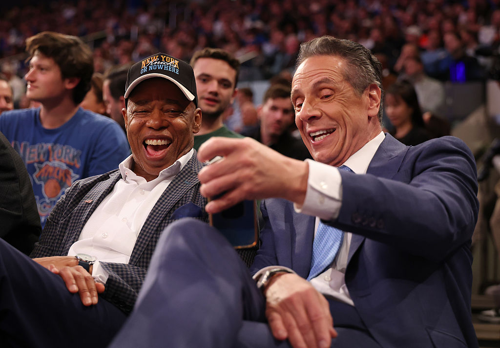 New York Mayor Eric Adams sits with Independent candidate former New York Gov. Andrew Cuomo after Cuomo participated in the second debate for the upcoming mayoral election on Wednesday evening during the game between the New York Knicks and the Cleveland Cavaliers at Madison Square Garden on October 22, 2025 in New York City.