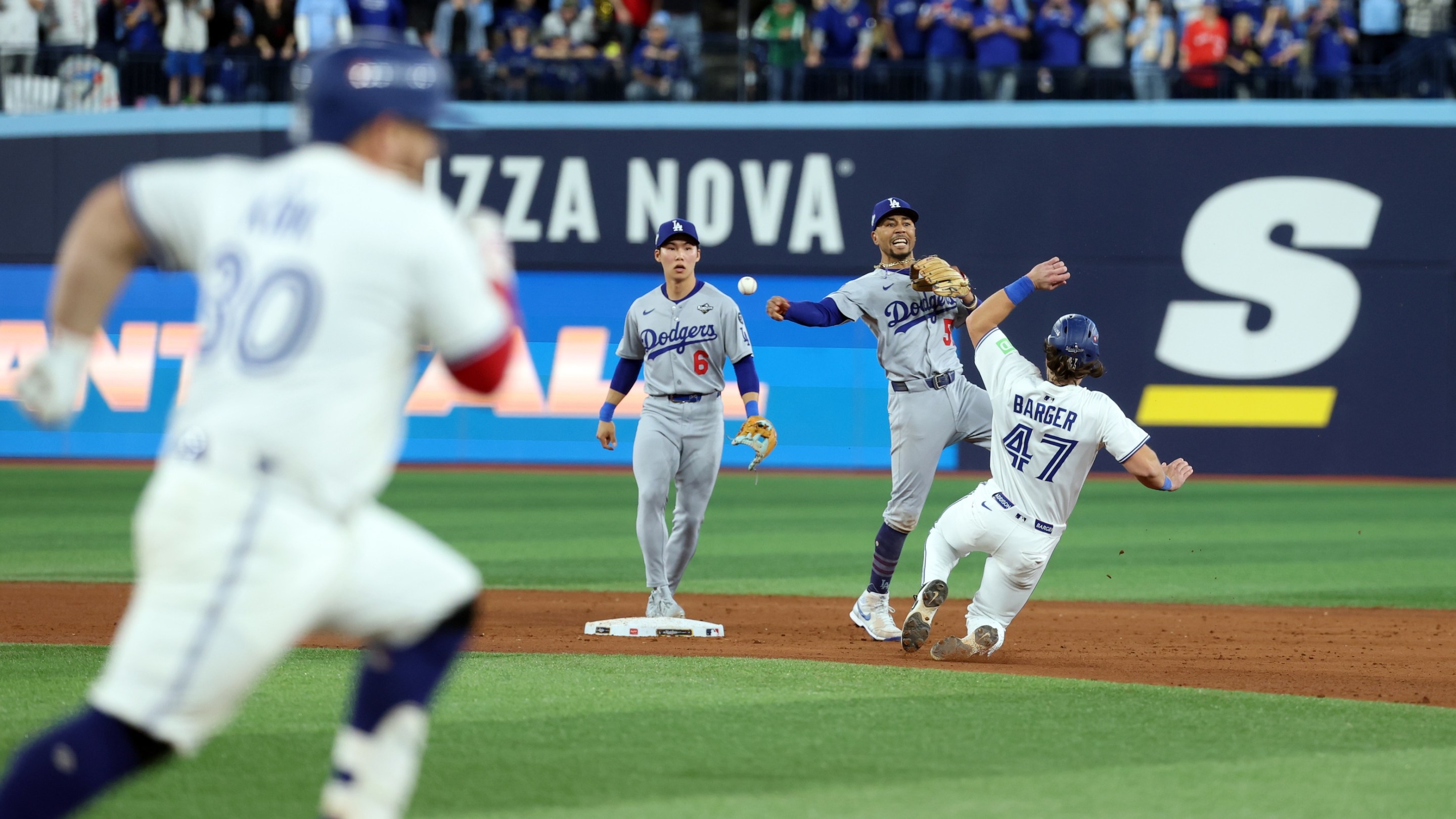 Mookie Betts of the Los Angeles Dodgers turns a game-ending double play to beat the Toronto Blue Jays in Game Seven of the 2025 World Series.