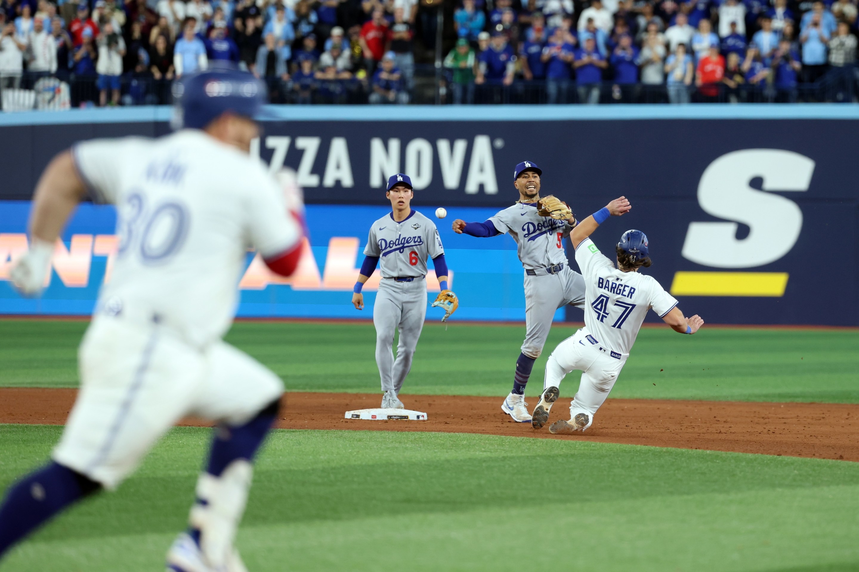 Mookie Betts of the Los Angeles Dodgers turns a game-ending double play to beat the Toronto Blue Jays in Game Seven of the 2025 World Series.