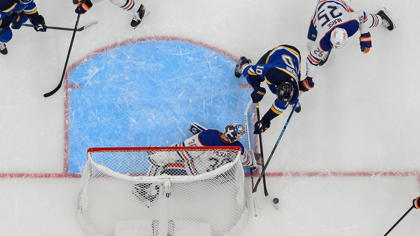 Calvin Pickard #30 and Darnell Nurse #25 of the Edmonton Oilers defend the net against Brayden Schenn
