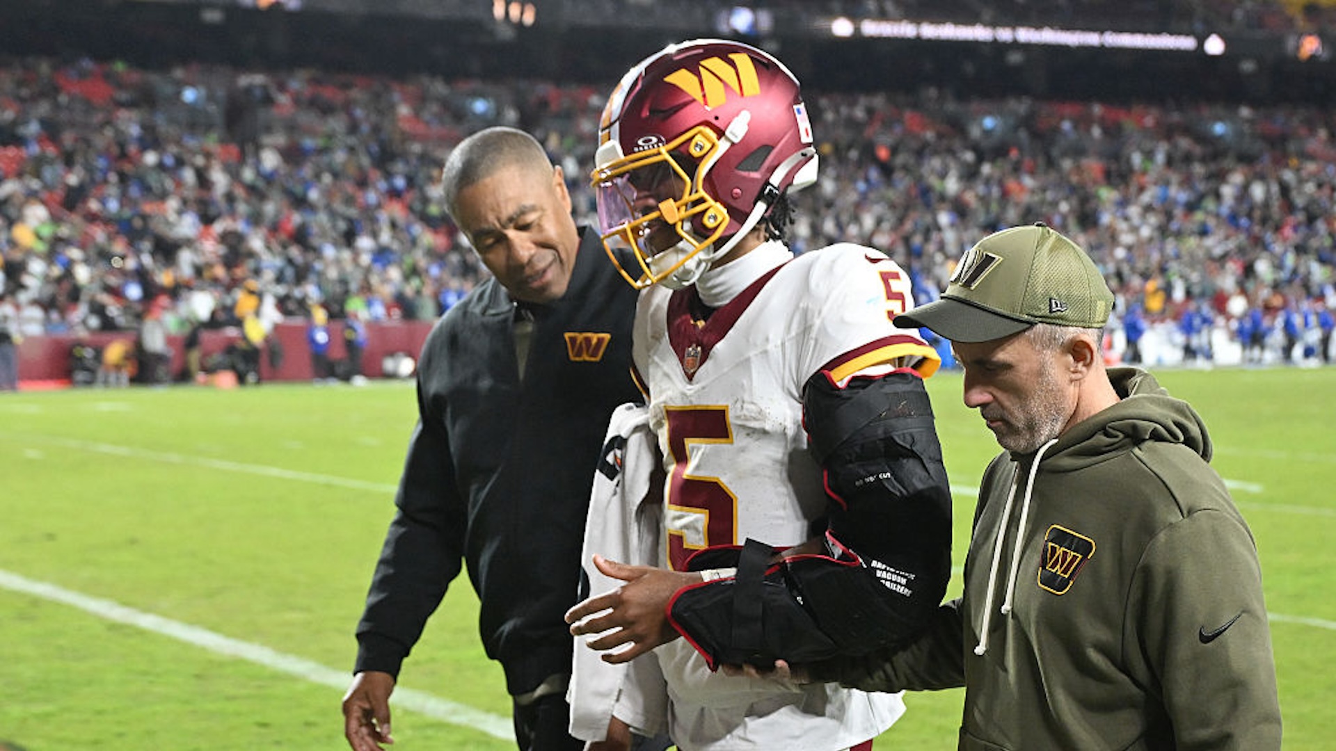 Jayden Daniels #5 of the Washington Commanders walks to the locker room after injuring his left arm during the fourth quarter against the Seattle Seahawks in the game at Northwest Stadium on November 02, 2025 in Landover, Maryland.