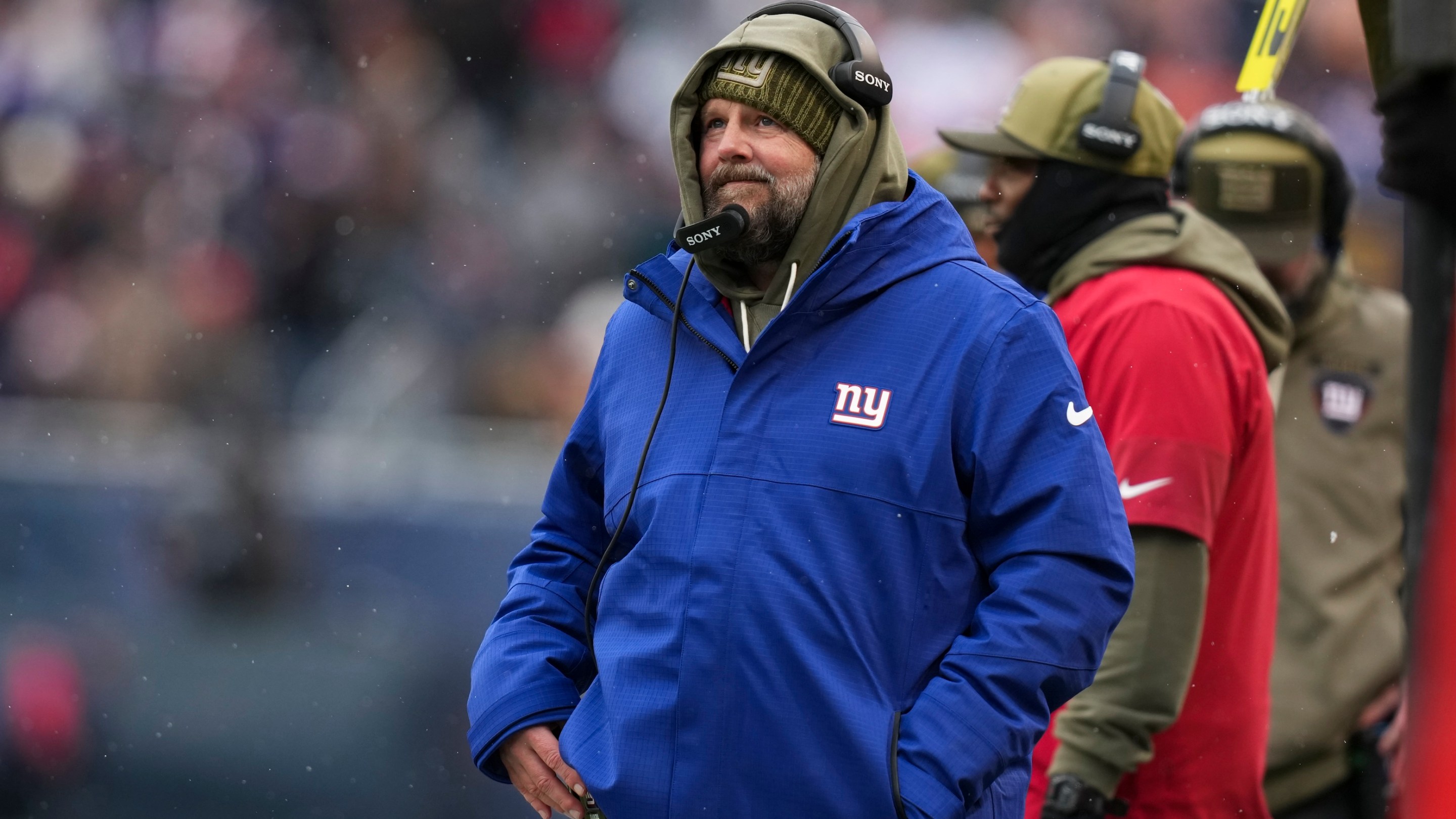 Brian Daboll of the New York Giants stands on the sideline during the second half of an NFL football game against the Chicago Bears on Sunday, November 9, 2025. It's snowing and he looks kind of frustrated.