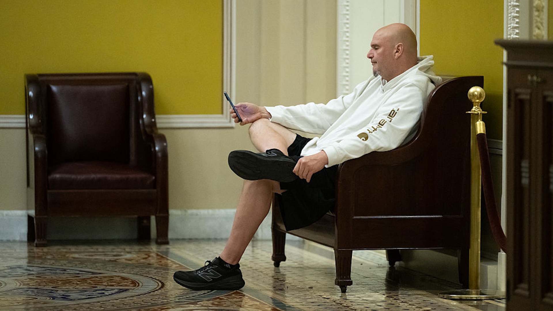 US Senator John Fetterman, Democrat of Pennsylvania, looks at his cellphone in between Senate votes to reopen the government on day 41 of the government shutdown at the US Capitol in Washington, DC, November 10, 2025. The longest-ever US government shutdown appeared headed Monday to an eventual resolution, after several Democratic senators broke ranks to join Republicans in advancing a compromise deal -- sparking intra-party backlash.