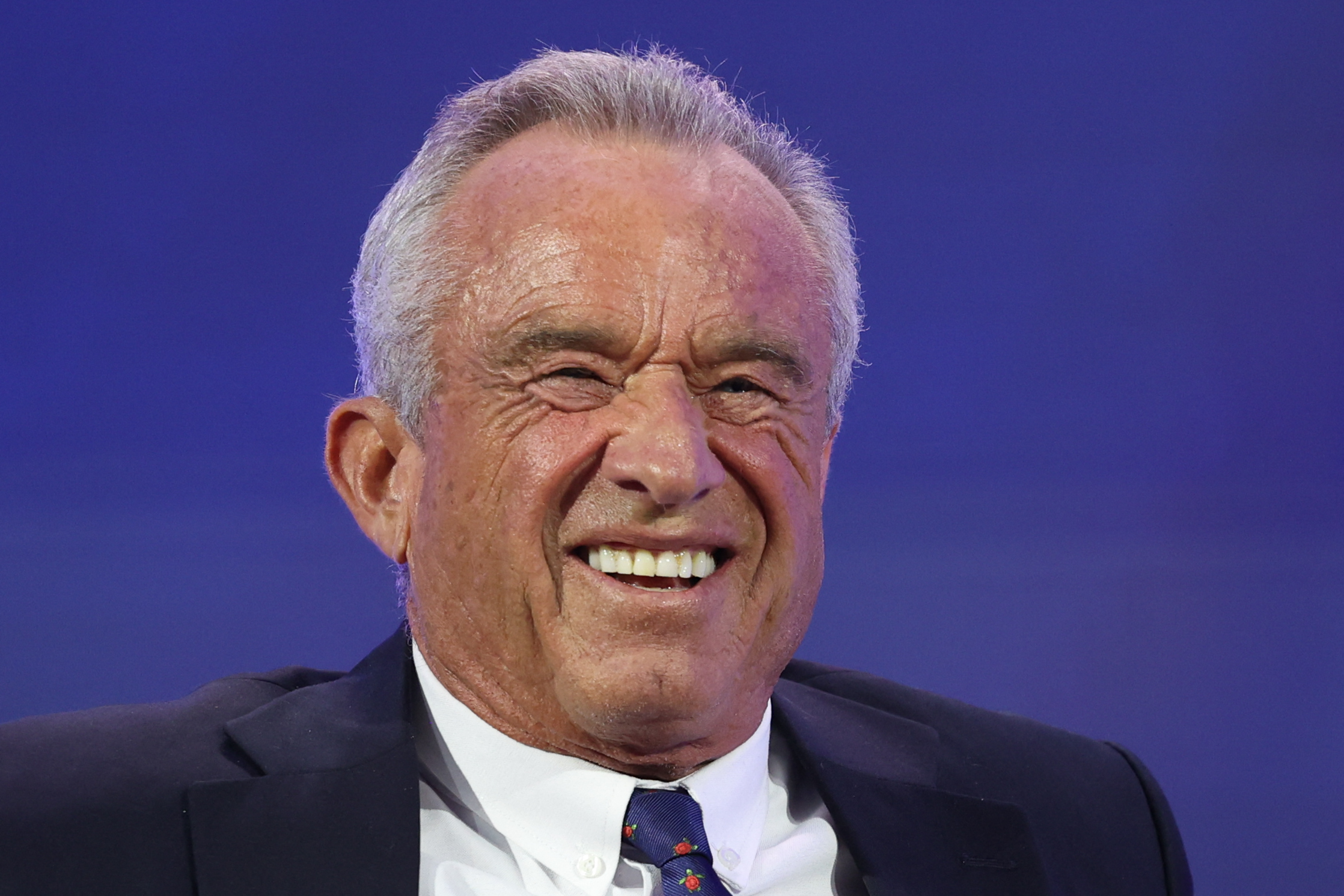 a photo of RFK Jr. where he looks like a broken Chuck-E-Cheeze animatronic