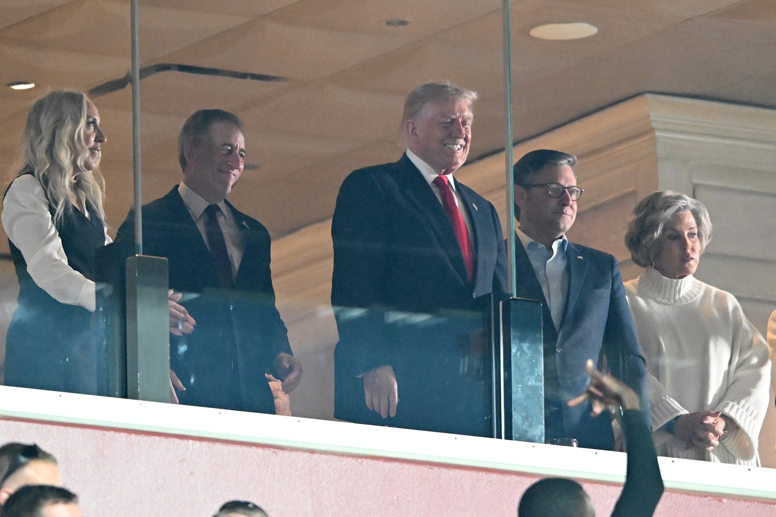 Donald Trump smiles woodenly from the owner's box at the Nov. 9 Commanders game.
