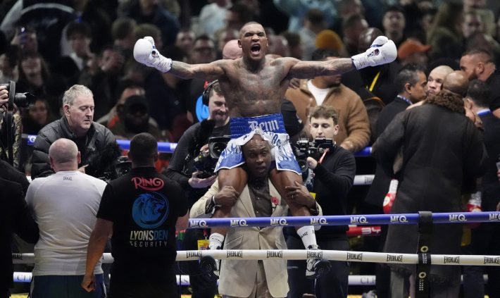 Conor Benn celebrates winning against Chris Eubank Jr at the Tottenham Hotspur Stadium, London. Conor Benn is sitting on top of his dad's shoulders and celebrating his win!