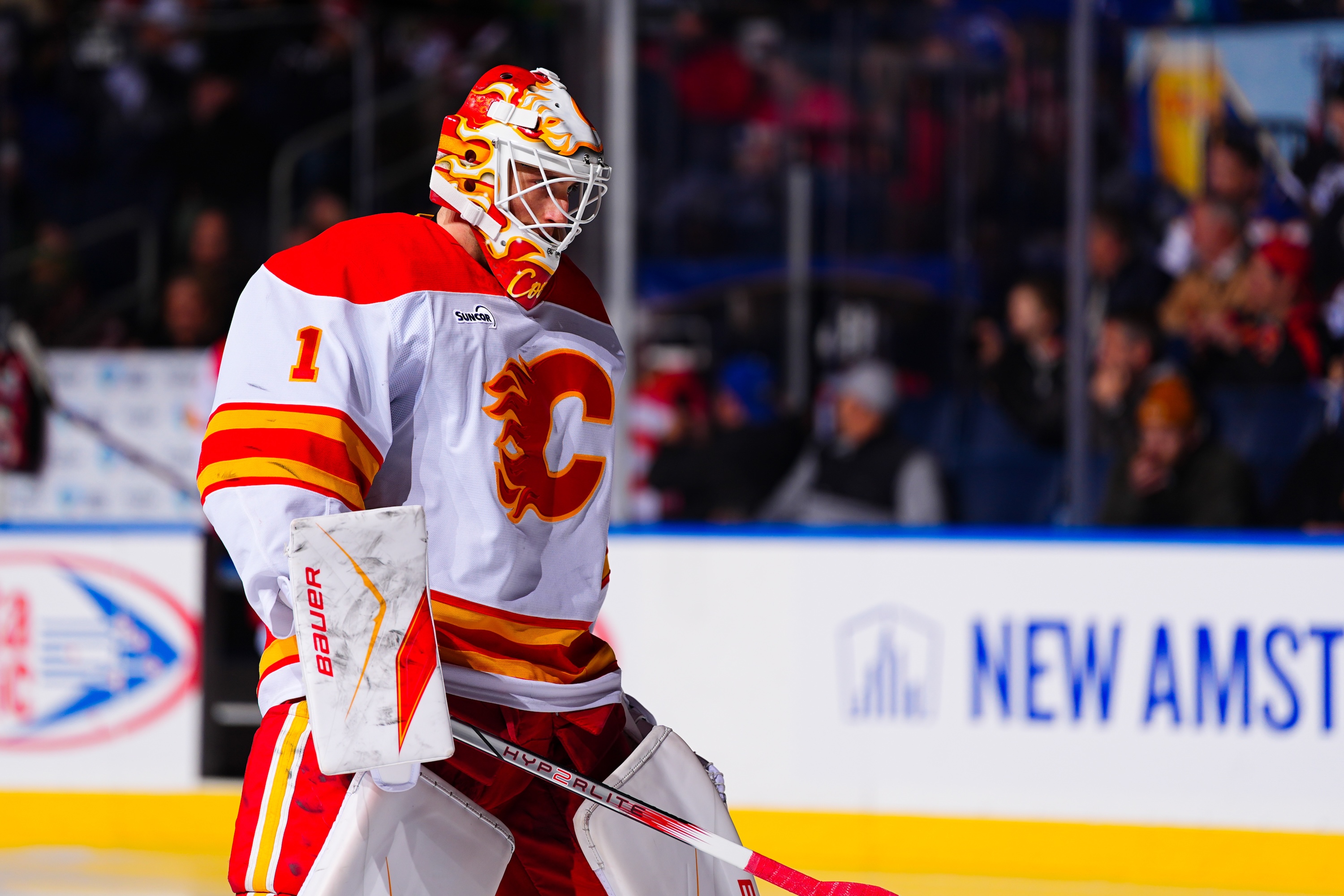 BUFFALO, NEW YORK - NOVEMBER 19: Devin Cooley #1 of the Calgary Flames stands during the singing of 'O Canada' prior to an NHL game on November 19, 2025 at KeyBank Center in Buffalo, New York. (Photo by Ben Ludeman/NHLI via Getty Images)
