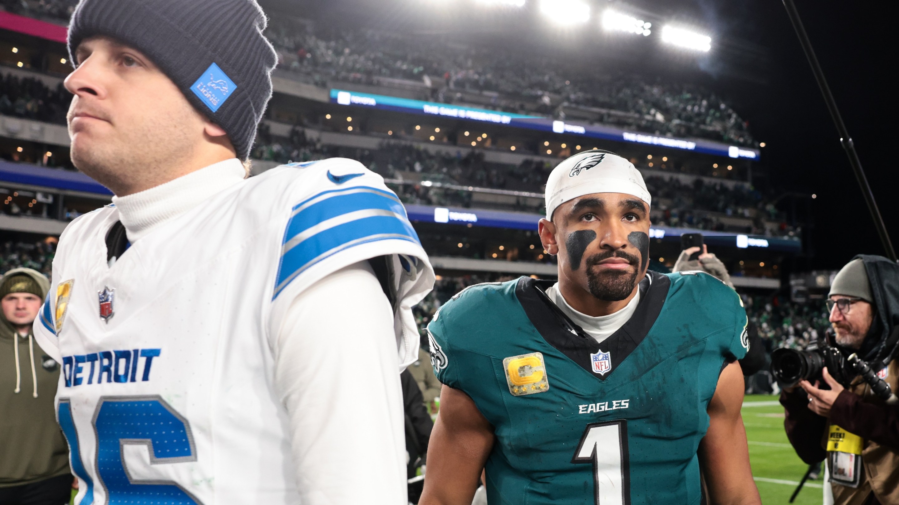 Jared Goff of the Detroit Lions and Jalen Hurts of the Philadelphia Eagles walk off the field after the game at Lincoln Financial Field on November 16, 2025 in Philadelphia, Pennsylvania.