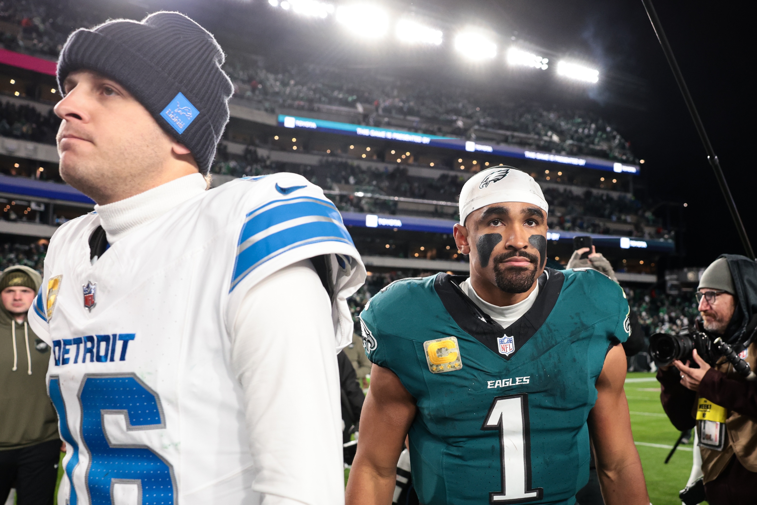 Jared Goff of the Detroit Lions and Jalen Hurts of the Philadelphia Eagles walk off the field after the game at Lincoln Financial Field on November 16, 2025 in Philadelphia, Pennsylvania.