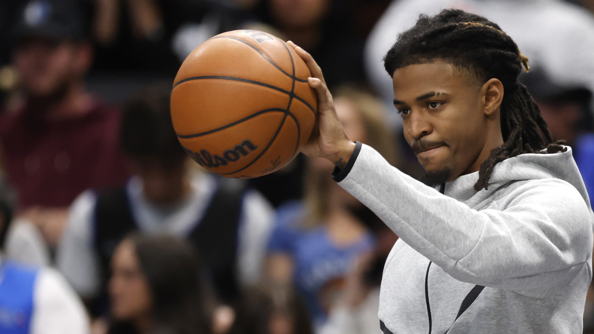 Ja Morant #12 of the Memphis Grizzlies looks on from the bench in the second half during timeout against the Dallas Mavericks at American Airlines Center on November 22, 2025 in Dallas, Texas.