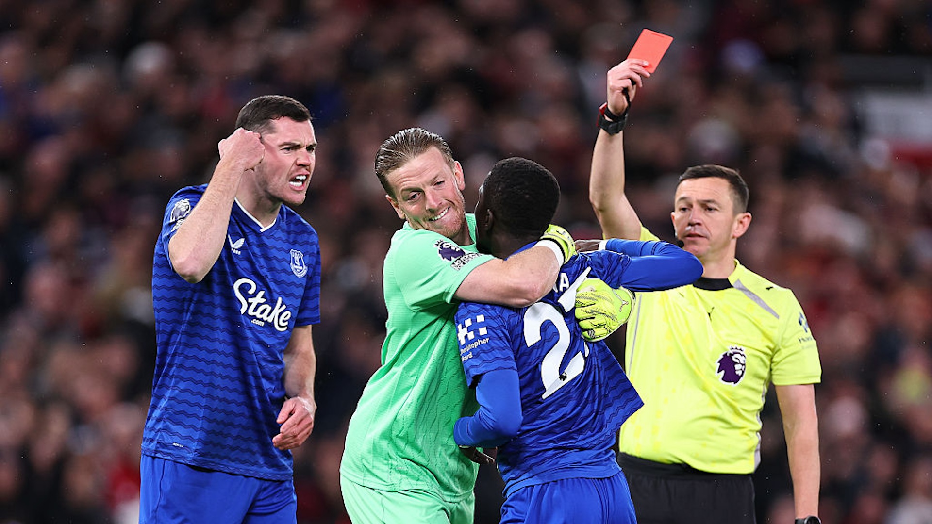 Idrissa Gueye of Everton receives a red card for a disagreement with Michael Keane of Everton during the Premier League match between Manchester United and Everton at Old Trafford on November 24, 2025 in Manchester, England.