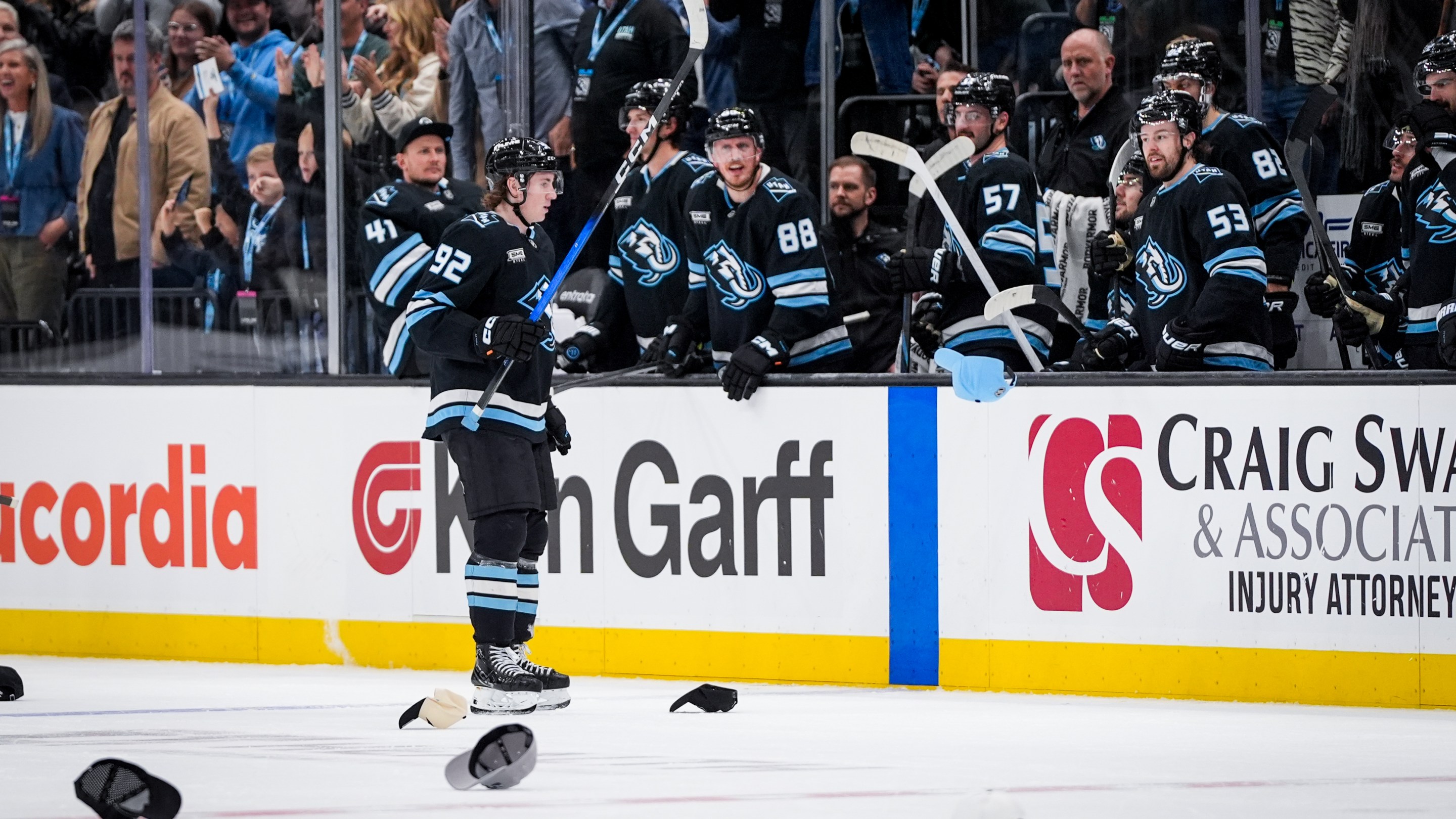Logan Cooley #92 of the Utah Mammoth celebrate a hat trick with the Utah Mammoth bench during the third period against the Vegas Golden Knights at Delta Center