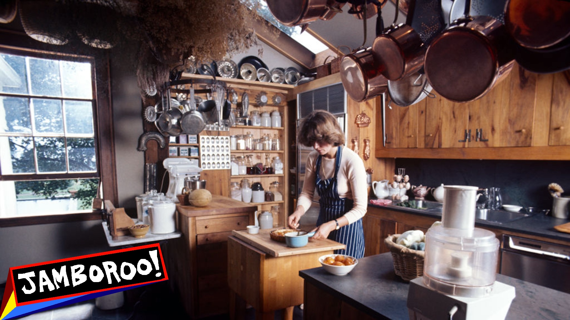 View of American media mogul and businesswoman Martha Stewart, in a blue, striped apron, as she works in her kitchen, Westport, Connecticut, August 1976.