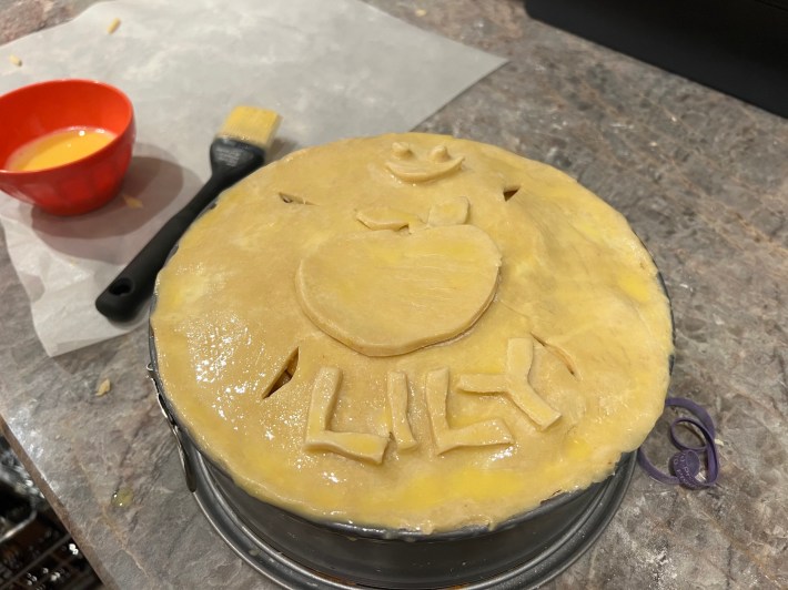 The pie with the top dough brushed with egg.