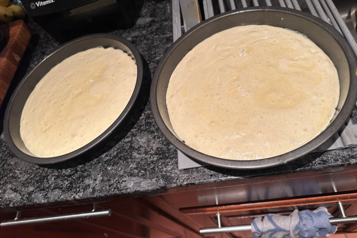 two pans with cake batter in them.