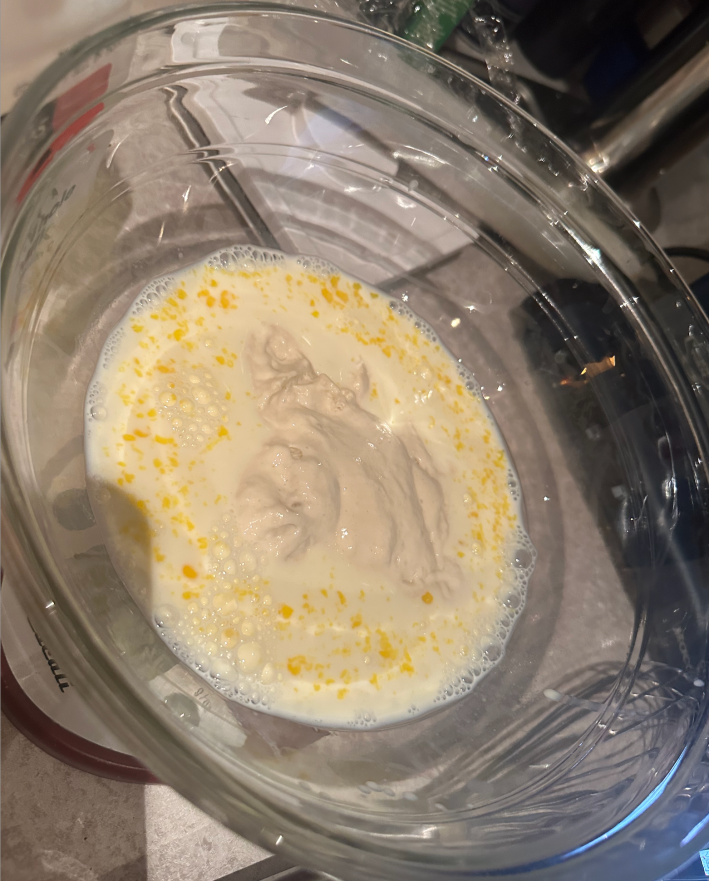 a bowl with egg and milk and starter
