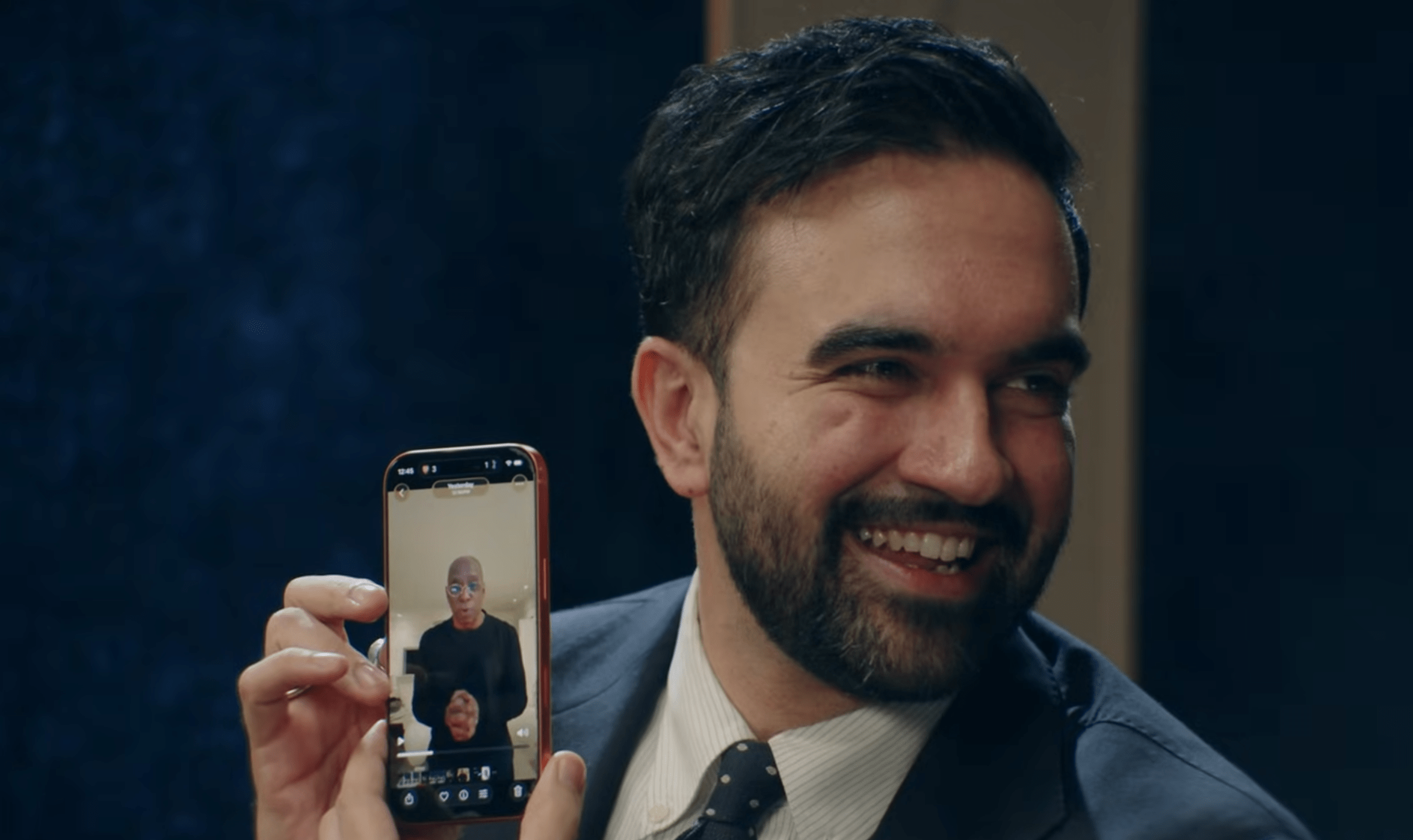 Zohran Mamdani holding up a photo of Ian Wright