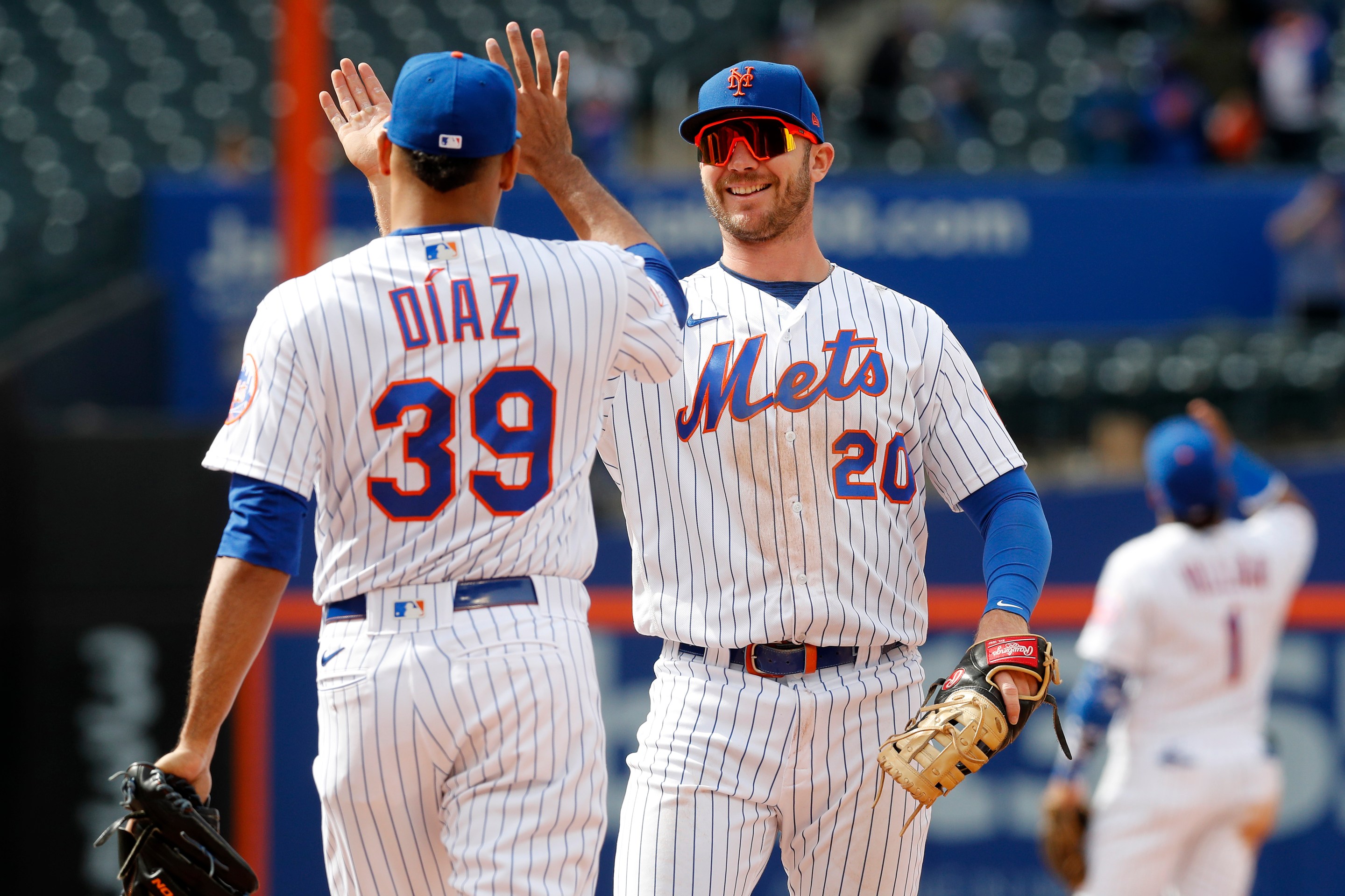 Pete Alonso #20 and Edwin Diaz #39 of the New York Mets celebrate after defeating the Washington Nationals