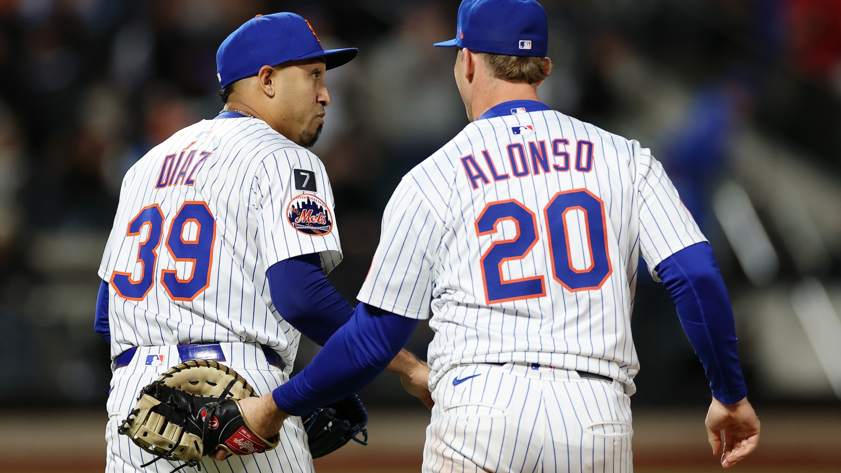 Edwin Diaz reacts with Pete Alonso of the New York Mets during the ninth inning against the St. Louis Cardinals at Citi Field on April 17, 2025. Alonso's kind of whapping Diaz on the butt with his glove.