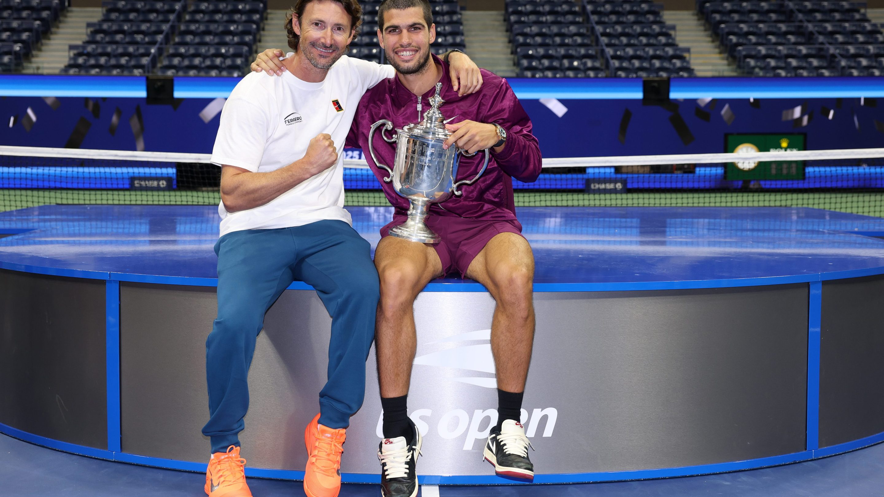 Carlos Alcaraz of Spain poses with his trophy next to his coach Juan Carlos Ferrero