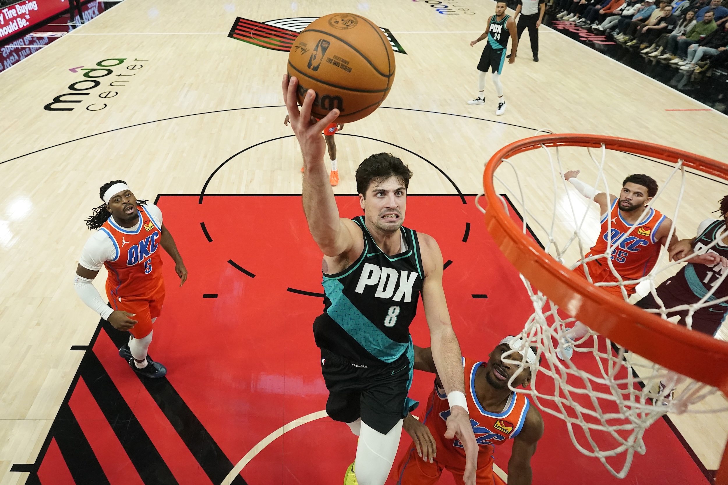 Deni Avdija grimaces while scoring