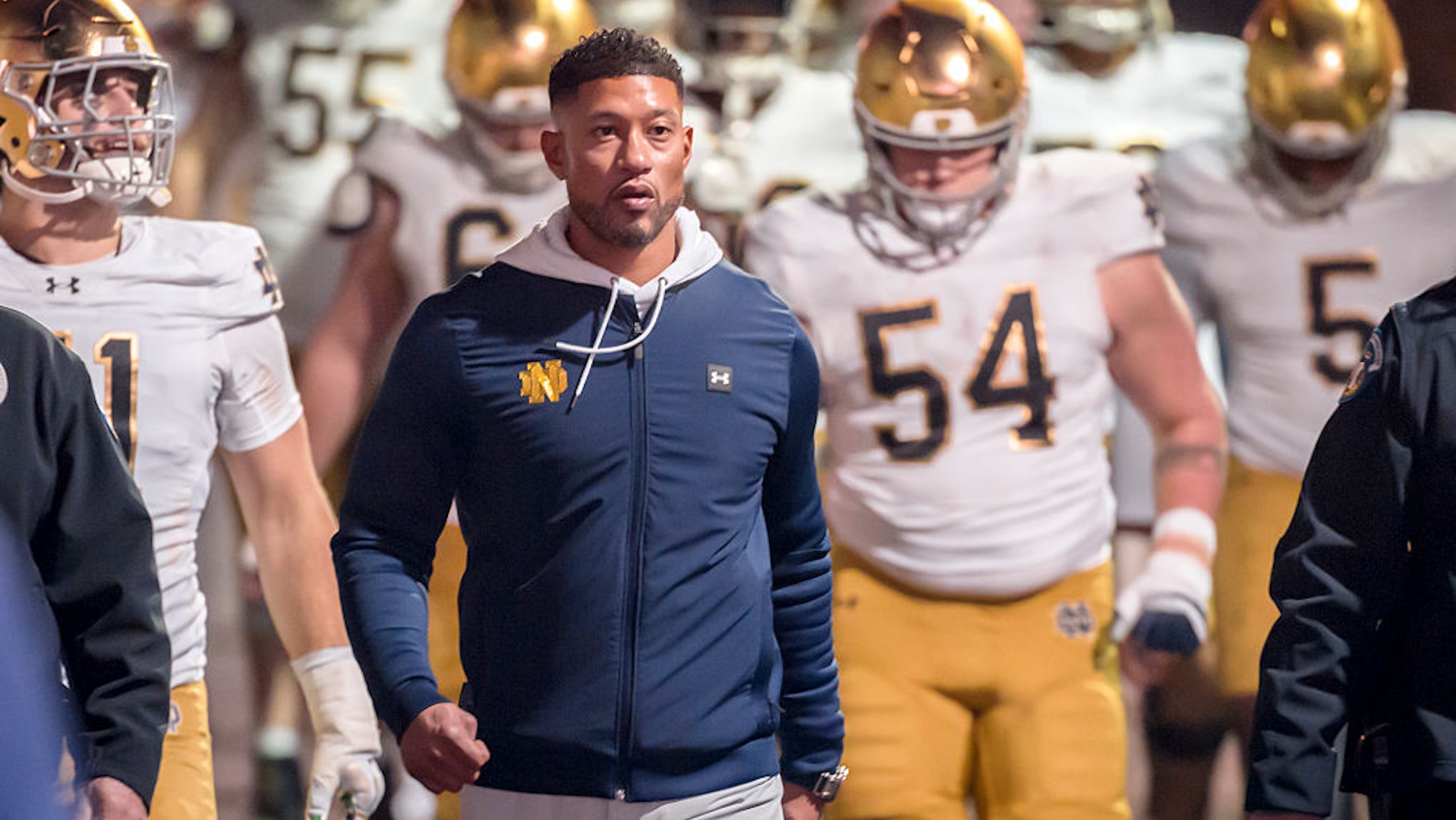 Head Coach Marcus Freeman of the Notre Dame Fighting Irish leads his team into the stadium to start the second half of a college football game against the Stanford Cardinal on November 29, 2025 at Stanford Stadium in Palo Alto, California.