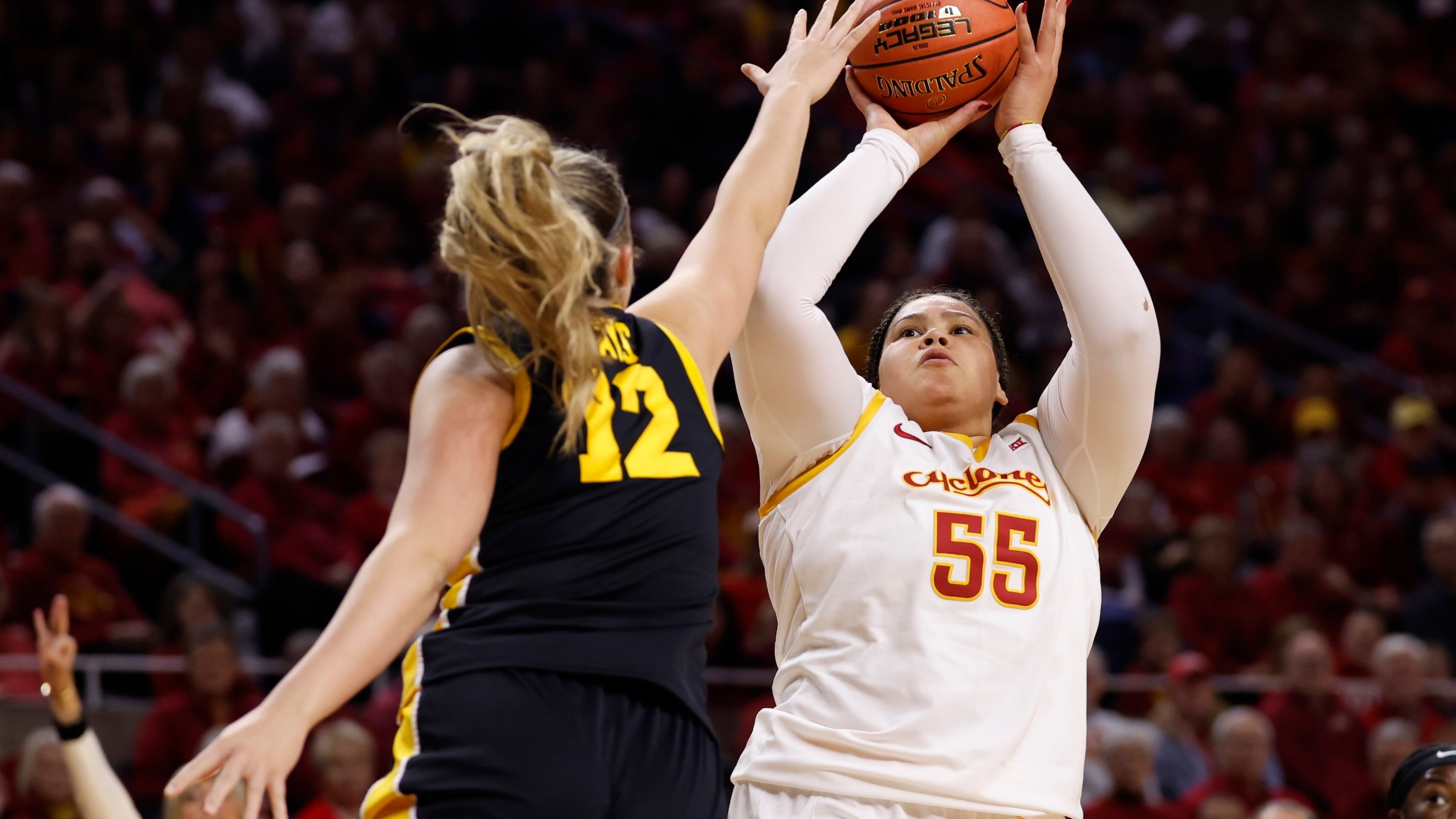 Audi Crooks #55 of the Iowa State Cyclones takes a shot as Layla Hays #12 of the Iowa Hawkeyes blocks in the first half of play at Hilton Coliseum on December 10, 2025, in Ames, Iowa.