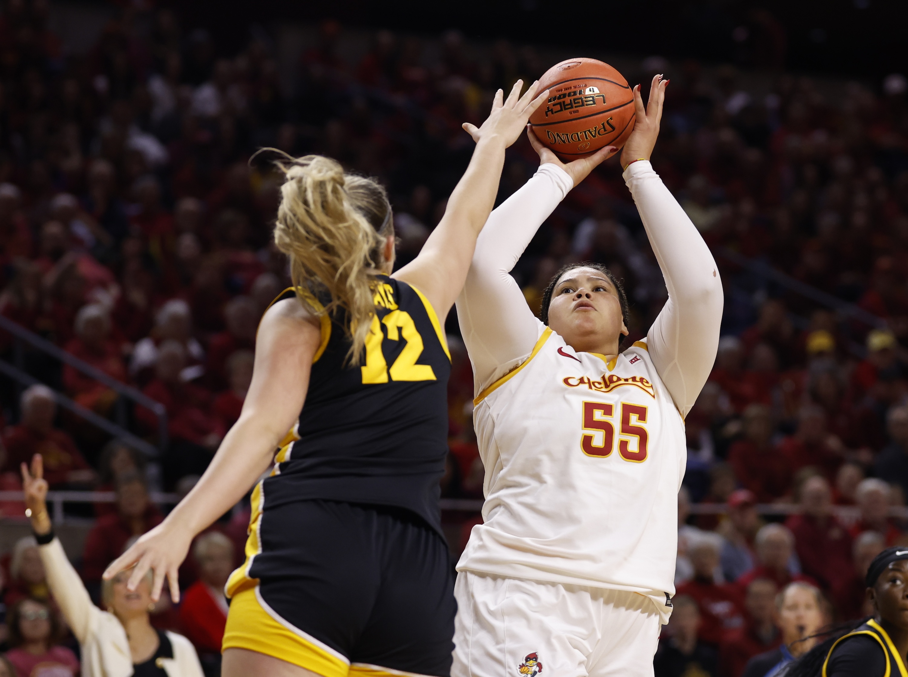 Audi Crooks #55 of the Iowa State Cyclones takes a shot as Layla Hays #12 of the Iowa Hawkeyes blocks in the first half of play at Hilton Coliseum on December 10, 2025, in Ames, Iowa.