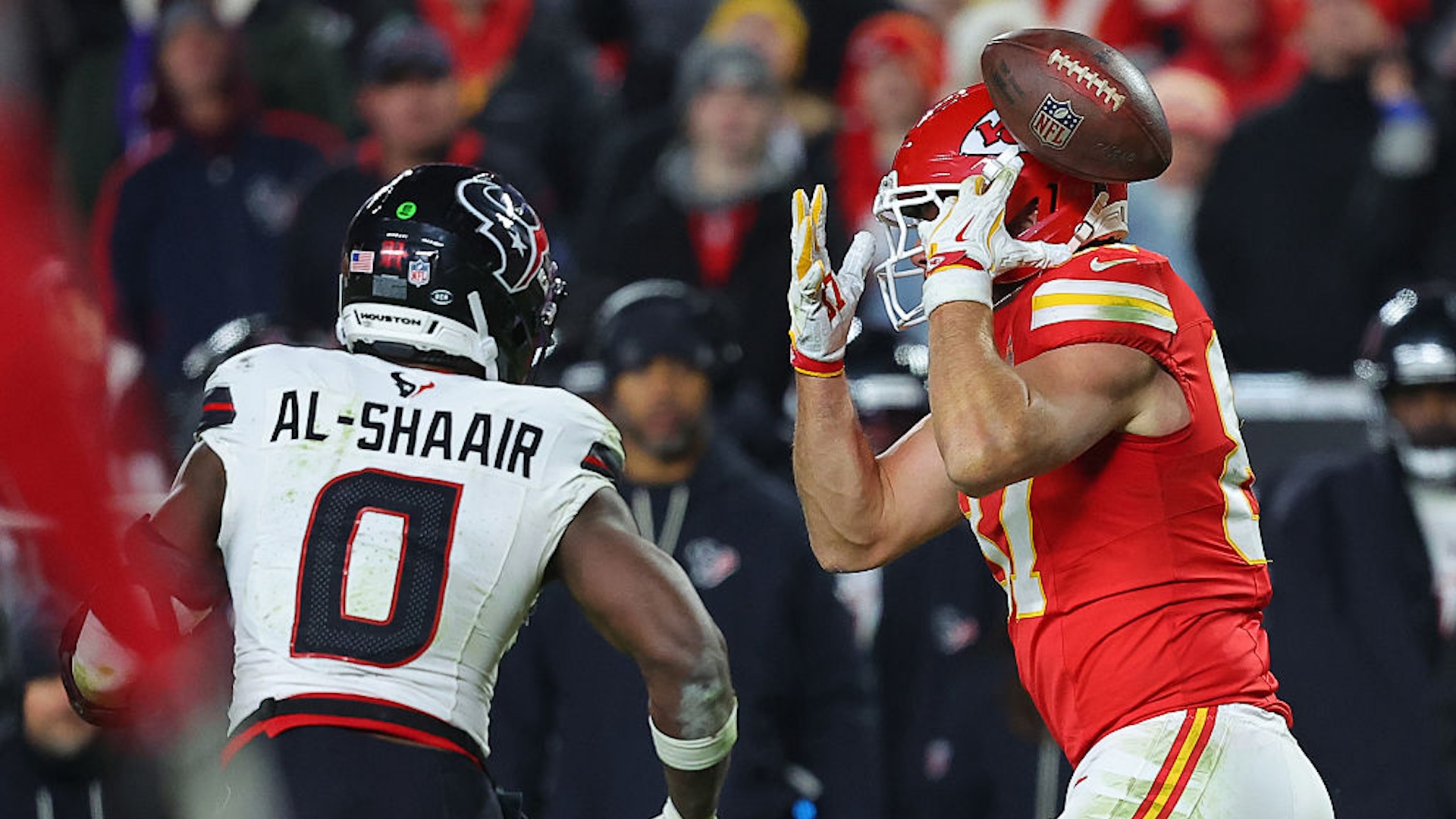 Azeez Al-Shaair #0 of the Houston Texans intercepts a pass intended for Travis Kelce #87 of the Kansas City Chiefs during the fourth quarter at Arrowhead Stadium on December 07, 2025 in Kansas City, Missouri.