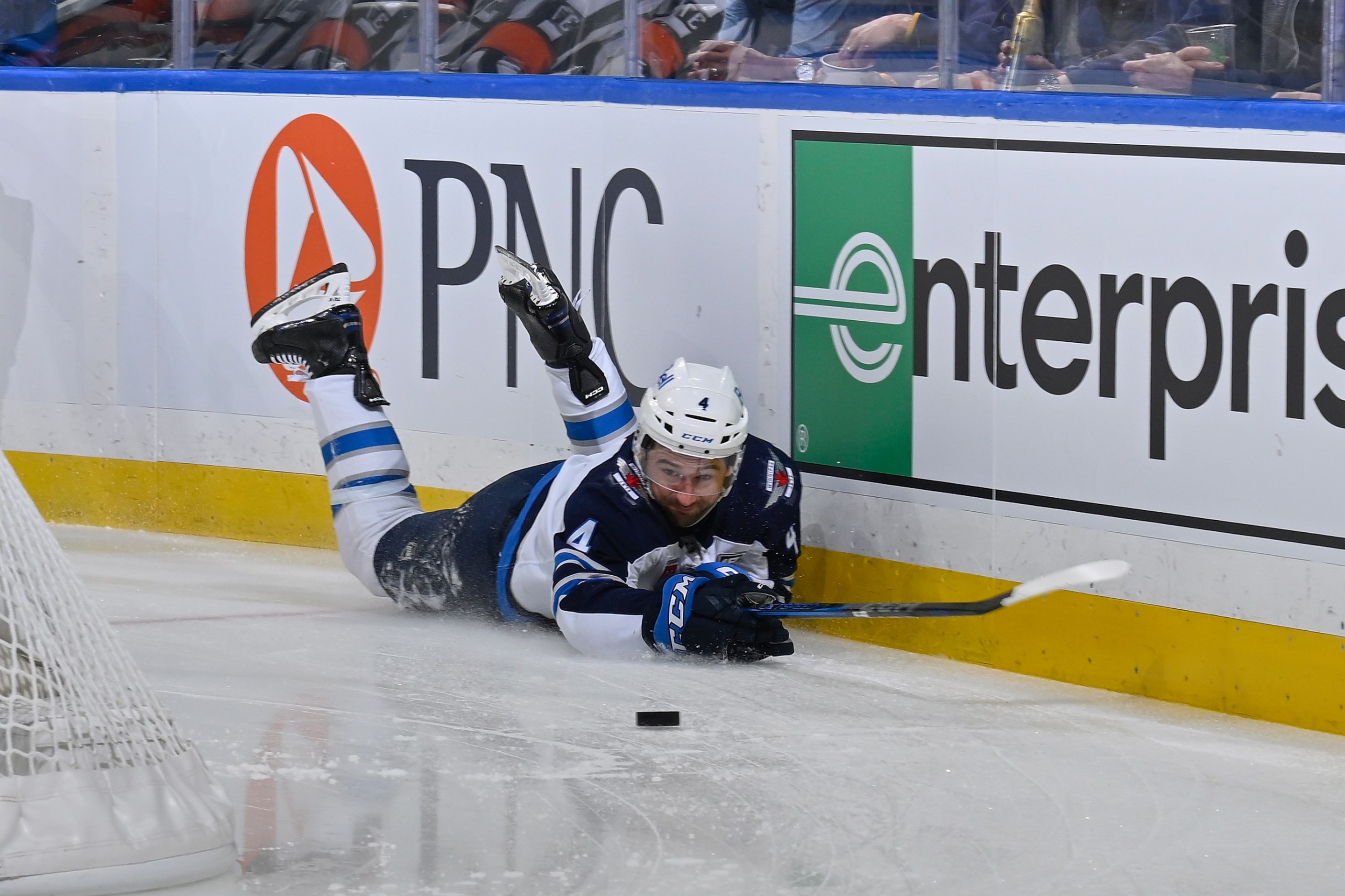 Neal Pionk #4 of the Winnipeg Jets falls to the ice during the game against the St. Louis Blues on December 17, 2025 at the Enterprise Center in St. Louis, Missouri.