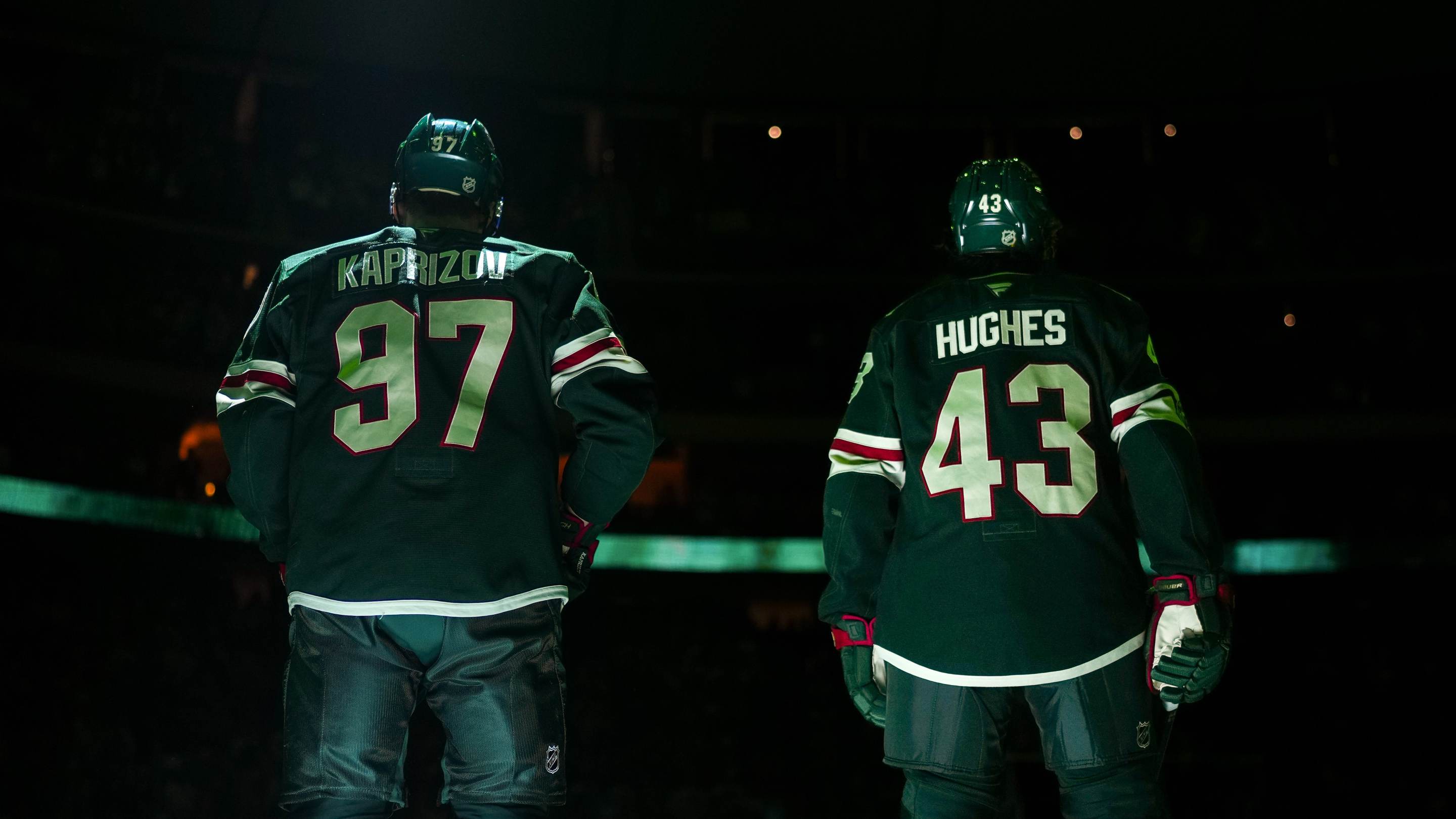 Kirill Kaprizov #97 and Quinn Hughes #43 of the Minnesota Wild stand on the blue line during the National Anthem