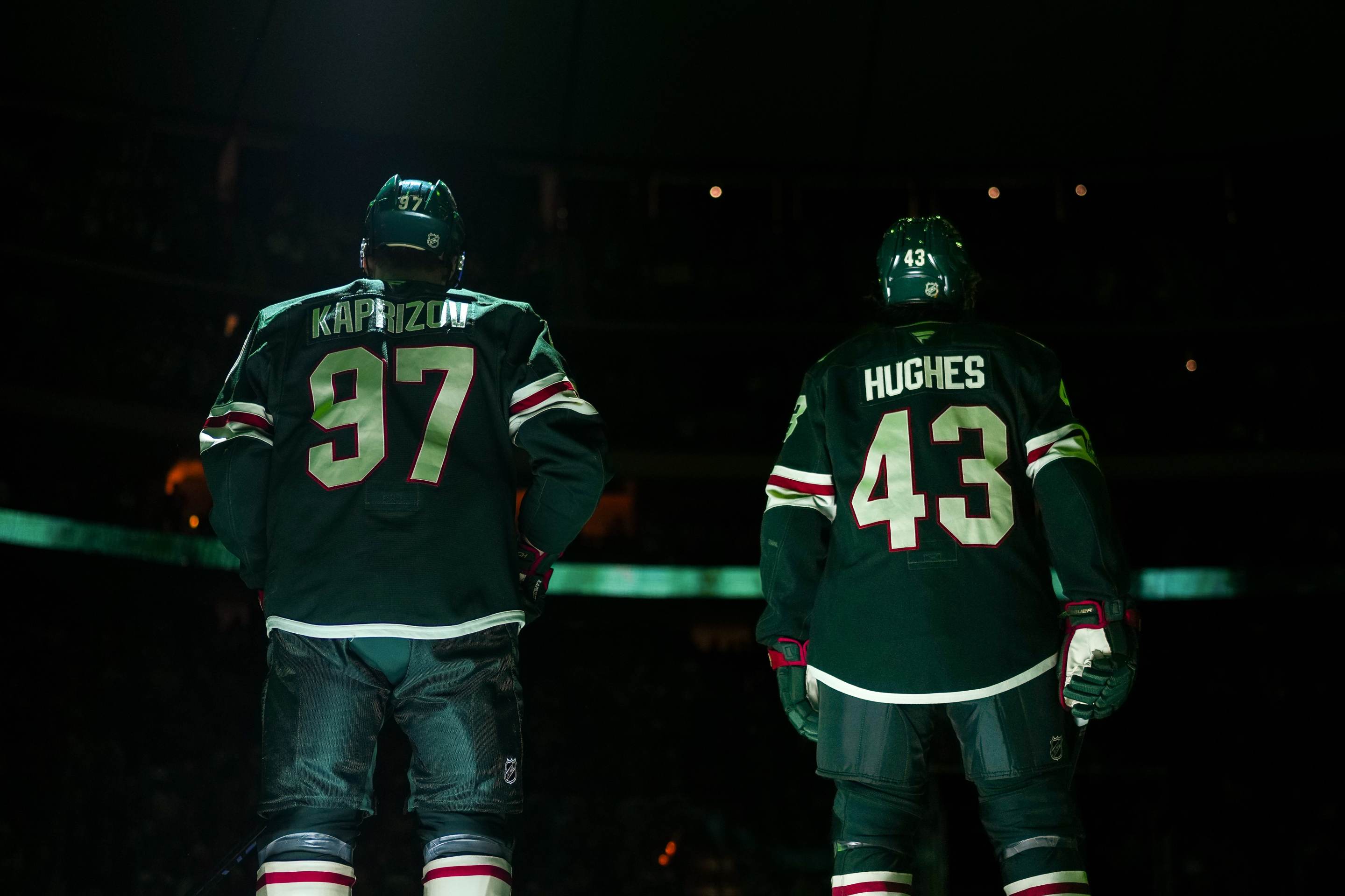 Kirill Kaprizov #97 and Quinn Hughes #43 of the Minnesota Wild stand on the blue line during the National Anthem