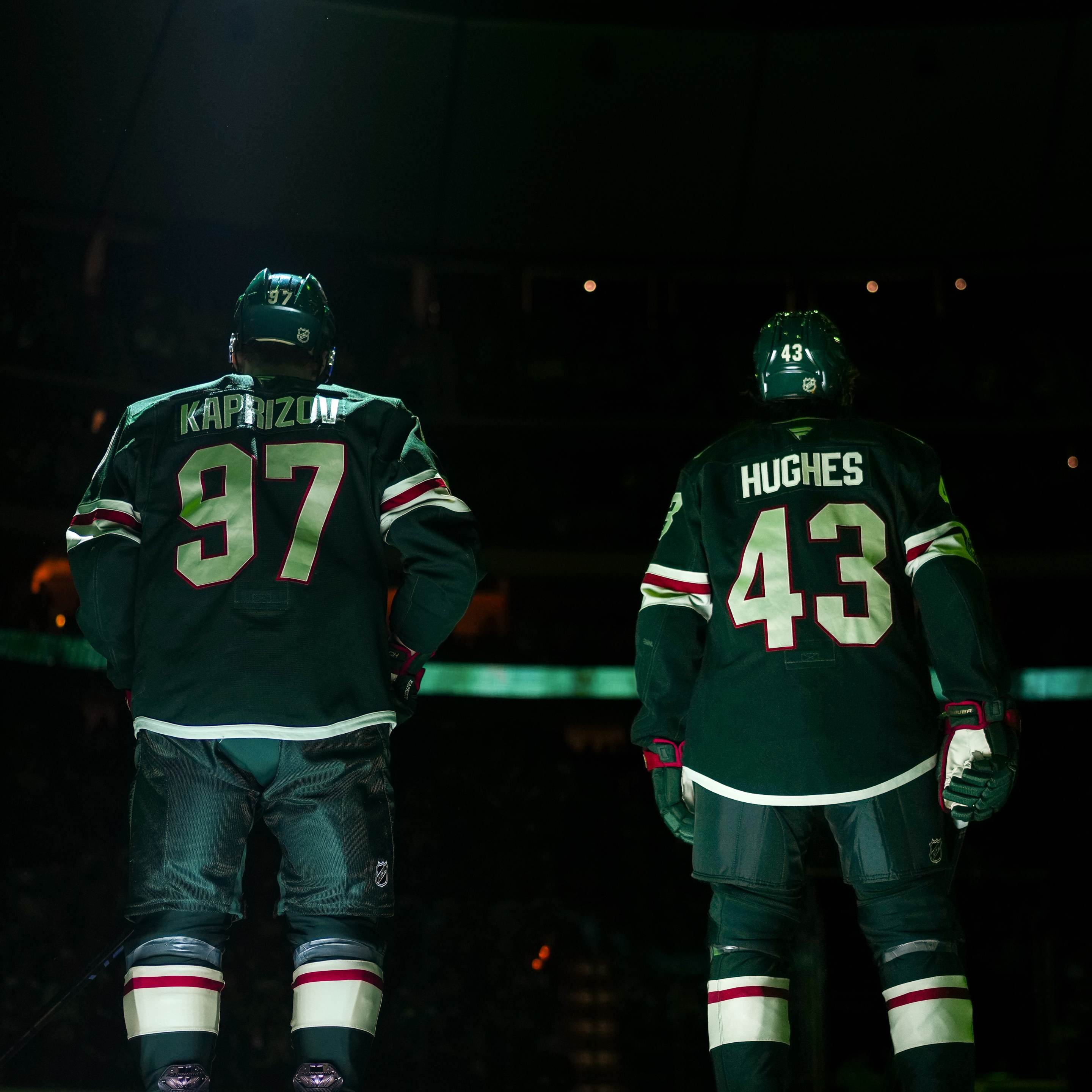 Kirill Kaprizov #97 and Quinn Hughes #43 of the Minnesota Wild stand on the blue line during the National Anthem