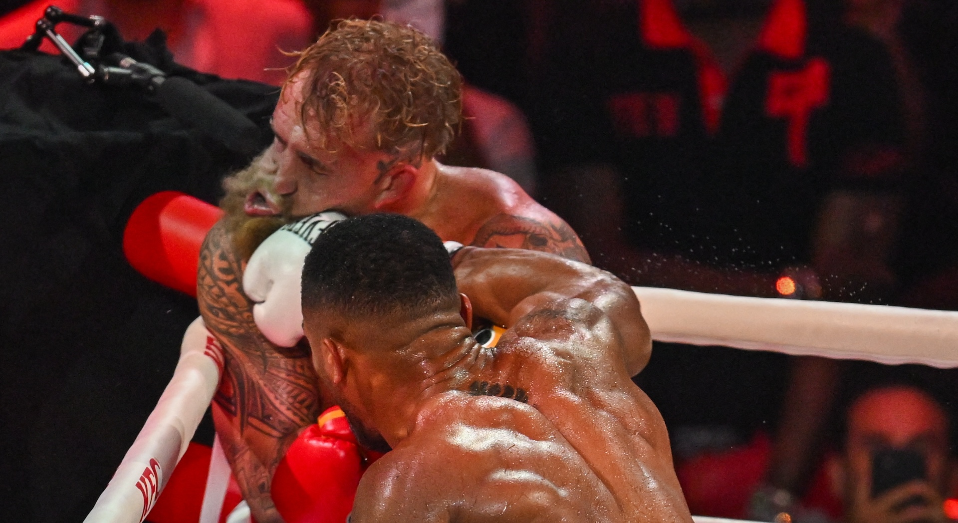 US boxer and influencer Jake Paul gets hit by British boxer Anthony Joshua (R) in a non-title heavyweight bout at the Kaseya Center in Miami, Florida on December 19, 2025.