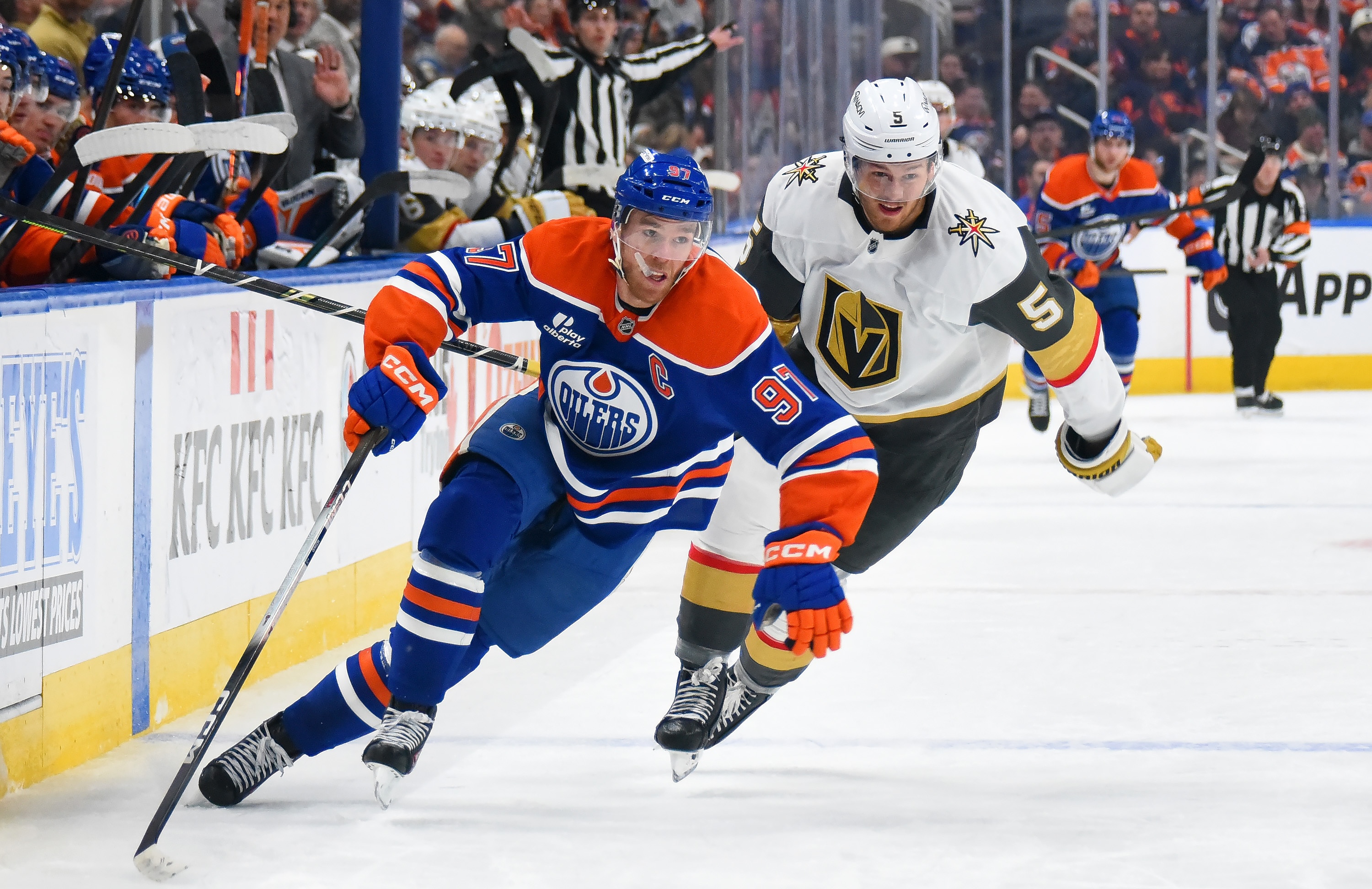 EDMONTON, CANADA - DECEMBER 21: Connor McDavid #97 of the Edmonton Oilers shields the puck from Jeremy Lauzon #5 of the Vegas Golden Knights during the second period of the game at Rogers Place on December 21, 2025, in Edmonton, Alberta, Canada. (Photo by Leila Devlin/Getty Images)