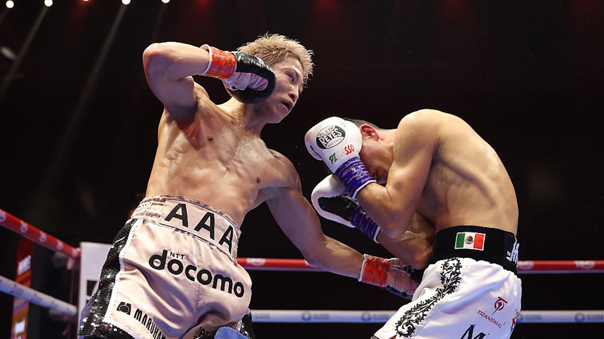 Naoya Inoue punches David Picasso during the IBF, WBC and WBO World Super Bantamweight title fight between Naoya Inoue and David Picasso during the Ring V: Night Of The Samurai fight night at Mohammed Abdo Arena on December 27, 2025 in Riyadh, Saudi Arabia.