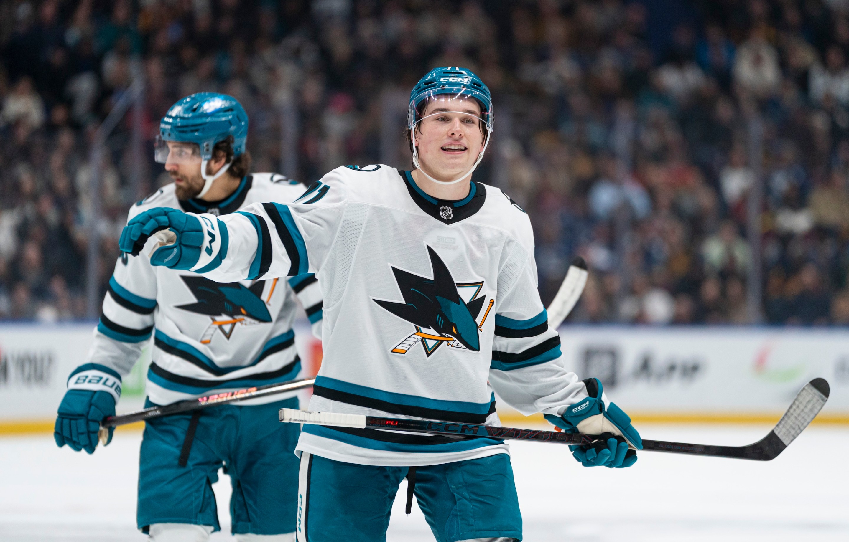VANCOUVER, CANADA - DECEMBER 27: Macklin Celebrini #71 of the San Jose Sharks gestures to a teammate prior to a face-off during NHL action against the Vancouver Canucks at Rogers Arena on December 27, 2025 in Vancouver, Canada. (Photo by Rich Lam/Getty Images)