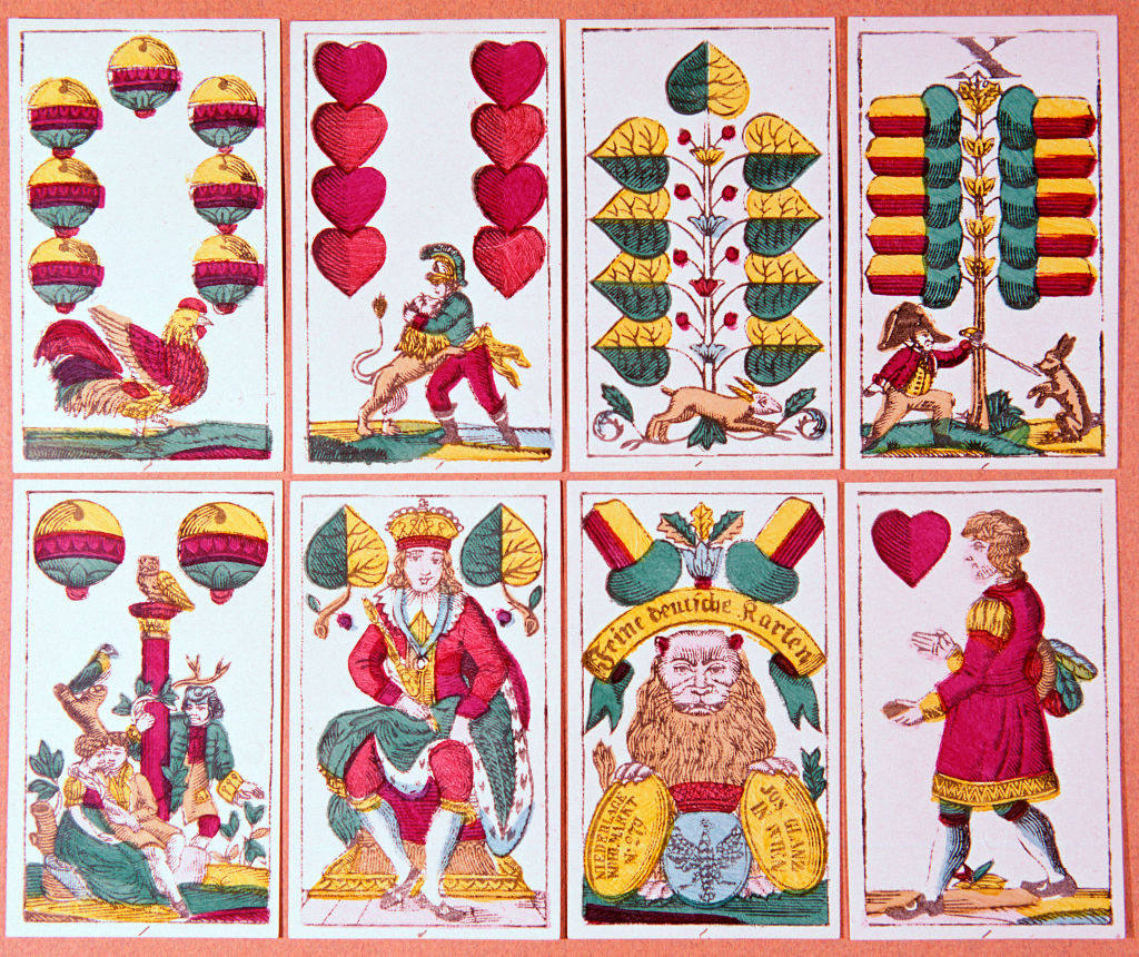 Austrian fortune-telling cards from a pack of 32, showing acorns, hearts, bells and leaves.