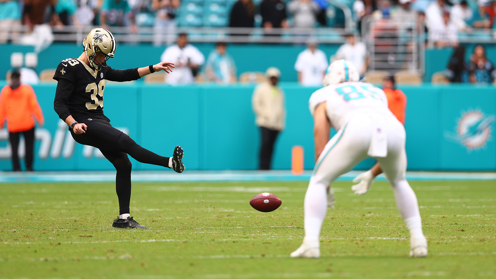 MIAMI GARDENS, FLORIDA - NOVEMBER 30: Charlie Smyth #39 of the New Orleans Saints attempts an onside kick against the Miami Dolphins during the fourth quarter at Hard Rock Stadium on November 30, 2025 in Miami Gardens, Florida.