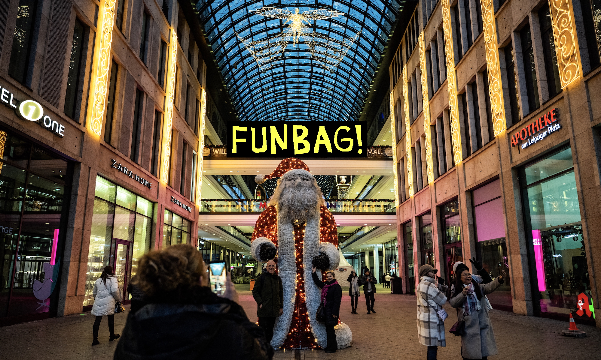 Pedestrians pose for pictures in front of a giant Santa Claus figure displayed in a shopping mall in Berlin, on December 24, 2024.