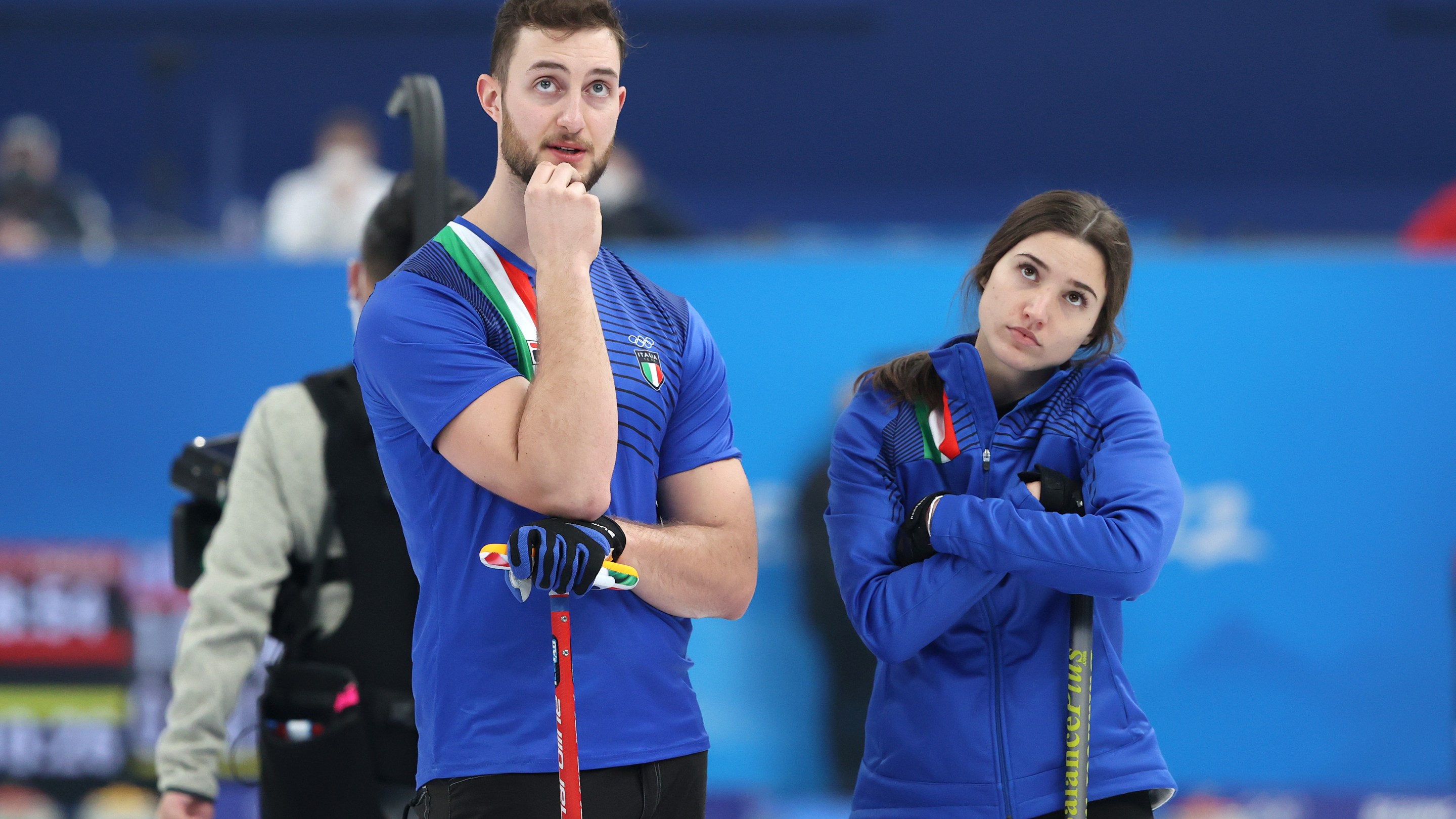 Stefania Constantini and Amos Mosaner of Team Italy look on against Team Switzerland during the Curling Mixed Doubles Round Robin ahead of the Beijing 2022 Winter Olympics