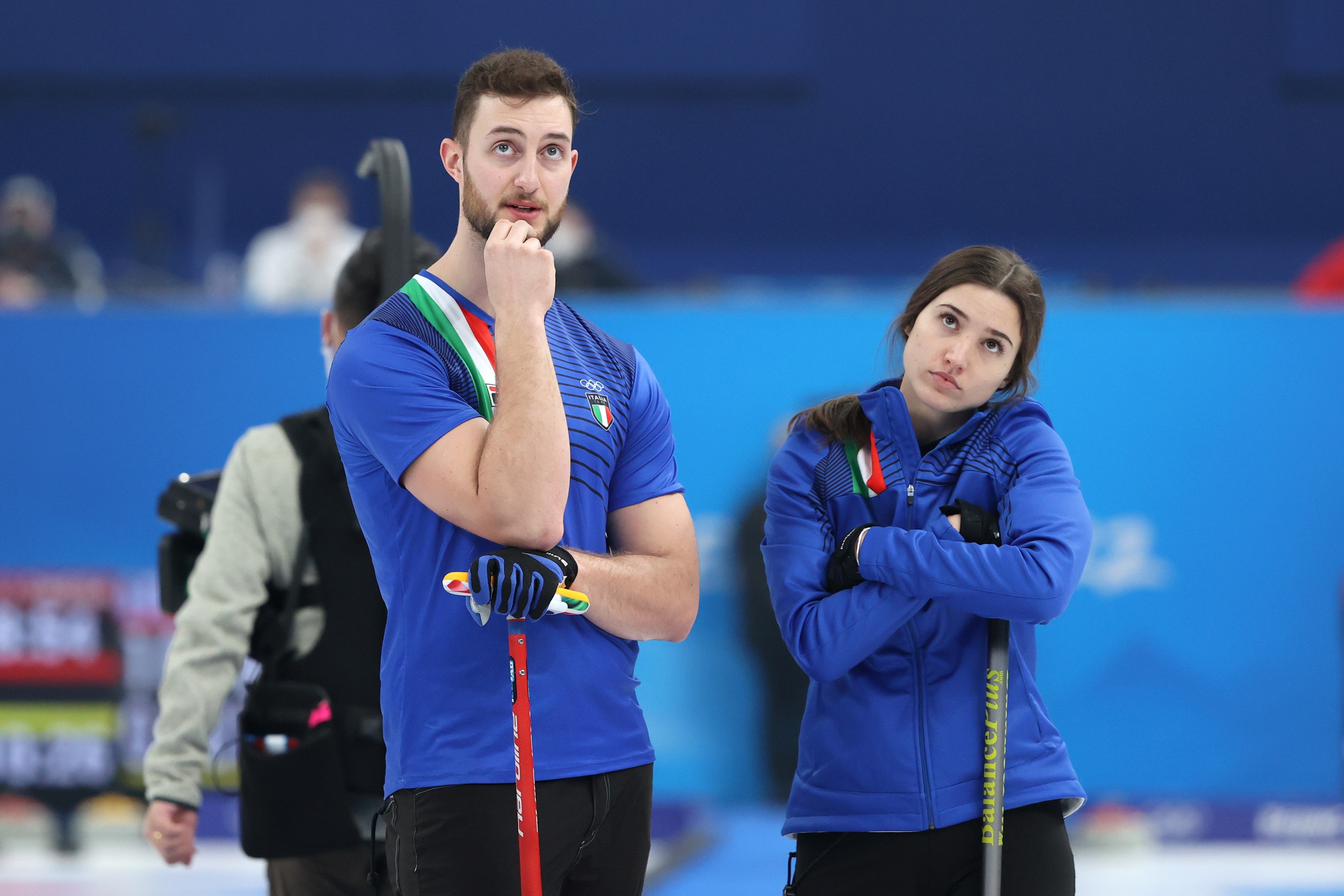 Stefania Constantini and Amos Mosaner of Team Italy look on against Team Switzerland during the Curling Mixed Doubles Round Robin ahead of the Beijing 2022 Winter Olympics