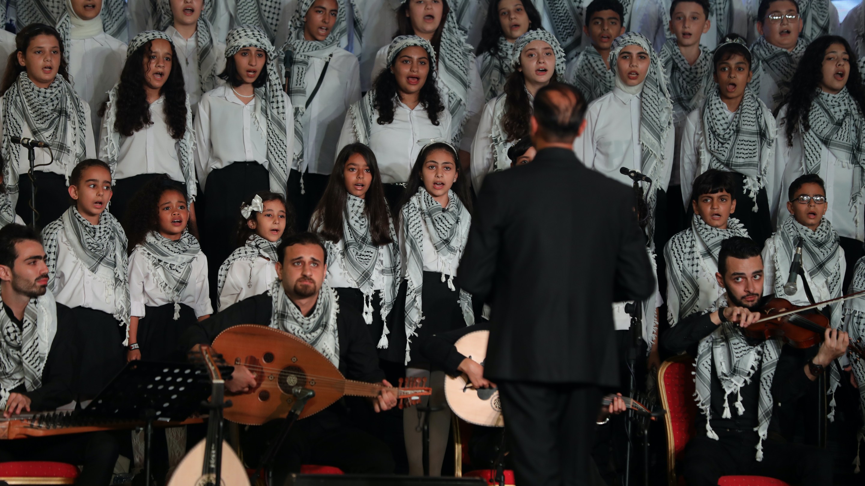 Young Palestinian choir members, attending an UNRWA-funded school, sing during a performance on July 18, 2023, in Gaza City.